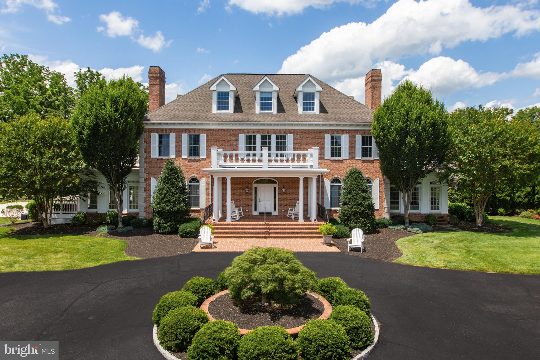 Welcome to this exceptional 7-bedroom, 4 full and 2 half-bath Federal-style estate nestled on private gated 4-acre lot in the exclusive Timberline Park community. Designed with timeless architecture, offering unmatched space and privacy, this distinguished property is the ultimate retreat for refined living. Step into the two-story foyer with elegant ceramic tile flooring and a dramatic dual curved staircase that sets the tone for the home. The main level is thoughtfully designed for both elegance and everyday convenience with seamless flow of formal and casual living spaces. At the heart of the home is a gourmet kitchen featuring stainless steel appliances, white cabinetry, Corian countertops, and a generous island with breakfast bar - perfect for entertaining or preparing meals with ease. Adjacent to the kitchen is a light-filled breakfast nook and an inviting sunken family room with a gas fireplace, creating a warm atmosphere. The formal living room and dining room provide spaces for entertaining guests, while a spacious den and bright sunroom offer multiple options for relaxation or creative use. A private office with built-ins and attached half bath is ideal for remote work or study. A beautifully remodeled bathroom with a walk-in shower adds function and accessibility to the main level, while the well-appointed mudroom with built-in storage ensures a tidy and organized entry from the garage or outdoors. Every detail—from rich hardwood flooring and custom trim work—elevates the comfort and sophistication of this level. The primary suite is a true sanctuary, complete with sitting room, dual walk-in closets for optimal storage and organization. The spa-inspired ensuite bath boasts a walk-in shower with a rain shower head, built-in bench, and recessed niche, as well as a soaking garden tub, and private water closet. Two additional generously sized bedrooms and two full bathrooms, add convenience for family or guests. A dedicated laundry room is also located on this level, strategically positioned for everyday ease. You'll find durable and stylish luxury vinyl plank flooring in upper levels, providing the look of hardwood with added resilience—ideal for both beauty and practicality. The third level features both space and character, with a full bathroom, four well-sized bedrooms with dormer windows that infuse the rooms with natural light and architectural charm. The finished basement is an extension of the home's versatility, offering an impressive array of spaces. A spacious recreation room featuring a gas fireplace and functional wet bar complete with white cabinetry, granite countertops, a stainless-steel refrigerator, and built-in microwave—perfect for hosting gatherings or creating the ultimate in-home lounge. For movie nights or game days, retreat to the dedicated media room, while the game room impresses with stained concrete floors, a second gas fireplace, and plenty of space for billiards, ping pong, or arcade-style fun. This level includes 3 multiple flexible-use spaces that can easily adapt to your lifestyle—whether as a bedroom, gym, playroom, craft space, or second home office. A half bathroom, large storage room, and walkout stairs leading directly to the rear deck, makes indoor-outdoor living easy. A spacious composite deck offers low-maintenance and style for outdoor dining or lounging. With steps leading to an expansive paver patio framed by retaining walls add dimension and structure to the landscape. A built-in firepit awaits evening gatherings under the stars. Professionally landscaped grounds surround the space with lush greenery, offering both beauty and privacy. For added fun, the backyard features a sand court, perfect for beach-style games, and a basketball court that doubles as extra parking for larger gatherings. Additional highlights include a detached 4-car garage with new insulated garage doors.