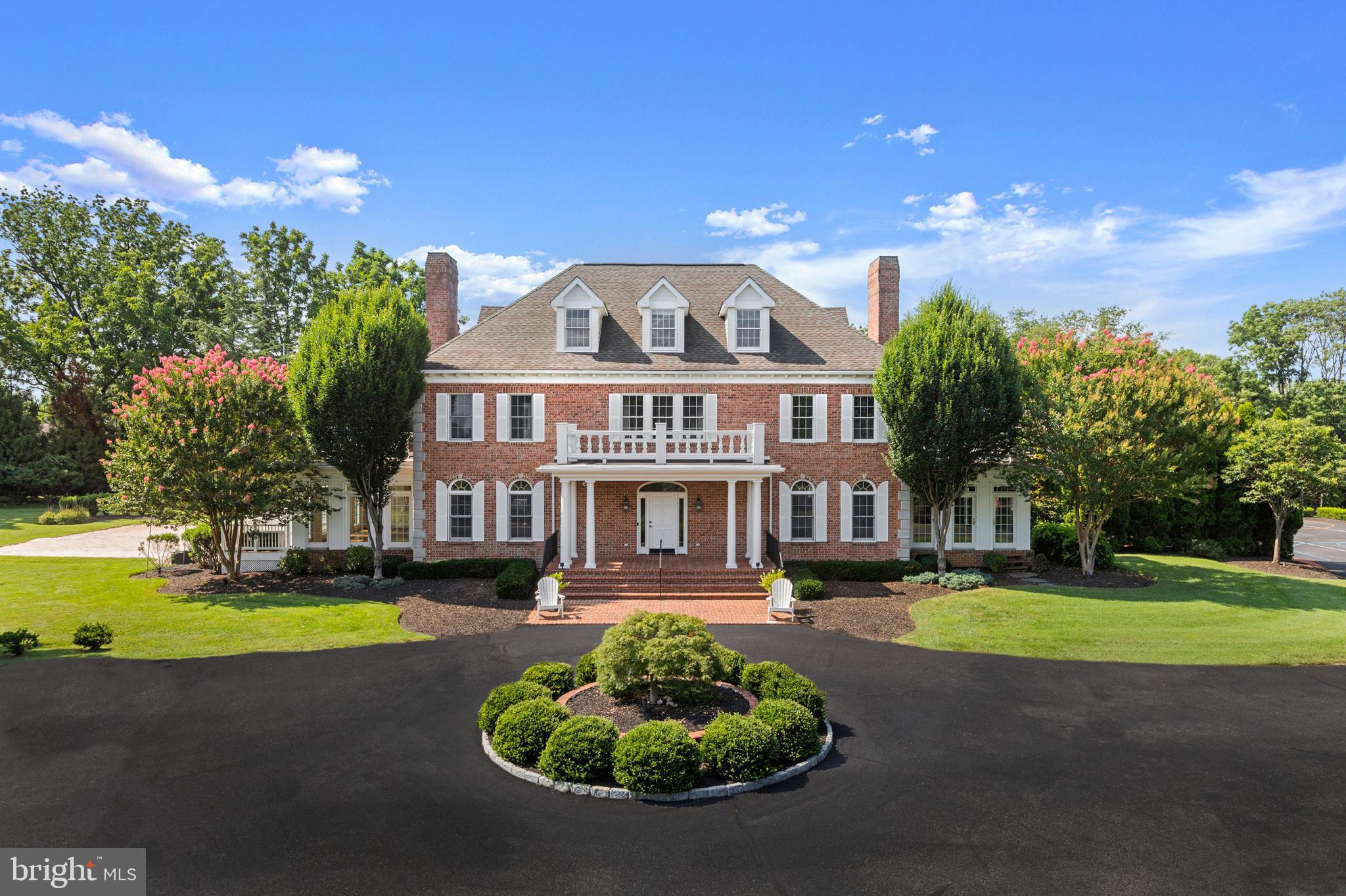 Welcome to this exceptional 7-bedroom, 5 full and 2 half-bath Federal-style estate nestled on private gated 4-acre lot in the exclusive Timberline Park community. Designed with timeless architecture, offering unmatched space and privacy, this distinguished property is the ultimate retreat for refined living. Step into the two-story foyer with elegant ceramic tile flooring and a dramatic dual curved staircase that sets the tone for the home. The main level is thoughtfully designed for both elegance and everyday convenience with seamless flow of formal and casual living spaces. At the heart of the home is a gourmet kitchen featuring stainless steel appliances, white cabinetry, Corian countertops, and a generous island with breakfast bar - perfect for entertaining or preparing meals with ease. Adjacent to the kitchen is a light-filled breakfast nook and an inviting sunken family room with a gas fireplace, creating a warm atmosphere. The formal living room and dining room provide spaces for entertaining guests, while a spacious den and bright sunroom offer multiple options for relaxation or creative use. A private office with built-ins and attached half bath is ideal for remote work or study. A beautifully remodeled bathroom with a walk-in shower adds function and accessibility to the main level, while the well-appointed mudroom with built-in storage ensures a tidy and organized entry from the garage or outdoors. Every detail—from rich hardwood flooring and custom trim work—elevates the comfort and sophistication of this level. The primary suite is a true sanctuary, complete with sitting room, dual walk-in closets for optimal storage and organization. The spa-inspired ensuite bath boasts a walk-in shower with a rain shower head, built-in bench, and recessed niche, as well as a soaking garden tub, and private water closet. Two additional generously sized bedrooms and two full bathrooms, add convenience for family or guests. A dedicated laundry room is also located on this level, strategically positioned for everyday ease. You'll find durable and stylish luxury vinyl plank flooring in upper levels, providing the look of hardwood with added resilience—ideal for both beauty and practicality. The third level features both space and character, with a full bathroom, four well-sized bedrooms with dormer windows that infuse the rooms with natural light and architectural charm. The finished basement is an extension of the home's versatility, offering an impressive array of spaces. A spacious recreation room featuring a gas fireplace and functional wet bar complete with white cabinetry, granite countertops, a stainless-steel refrigerator, and built-in microwave—perfect for hosting gatherings or creating the ultimate in-home lounge. For movie nights or game days, retreat to the dedicated media room, while the game room impresses with stained concrete floors, a second gas fireplace, and plenty of space for billiards, ping pong, or arcade-style fun. This level includes 3 multiple flexible-use spaces that can easily adapt to your lifestyle—whether as a bedroom, gym, playroom, craft space, or second home office. A half bathroom, large storage room, and walkout stairs leading directly to the rear deck, makes indoor-outdoor living easy. A spacious composite deck offers low-maintenance and style for outdoor dining or lounging. With steps leading to an expansive paver patio framed by retaining walls add dimension and structure to the landscape. A built-in firepit awaits evening gatherings under the stars. Professionally landscaped grounds surround the space with lush greenery, offering both beauty and privacy. For added fun, the backyard features a sand court, perfect for beach-style games, and a basketball court that doubles as extra parking for larger gatherings. Additional highlights include a detached 4-car garage with new insulated garage doors.
