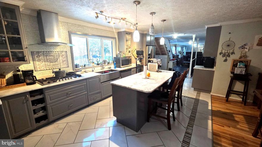 7905 Sarakal Rd | Clinton, MD 20735
***Showings will begin Monday Feb 9th after 1230p*****
Welcome to 7905 Sarakal Rd, a rare and expansive single-family detached home tucked away on a quiet, private street in Clinton—yet just minutes from major commuter routes, shopping, dining, and local entertainment. This home delivers the perfect blend of convenience, privacy, and serious space for today’s modern, multi-generational lifestyle.

Offering over 4,000 square feet, this impressive residence features 5 bedrooms and 3.5 baths, thoughtfully designed to comfortably accommodate immediate and extended family members under one roof.

The main level showcases a gourmet kitchen that flows effortlessly into an open dining area highlighted by a wood-burning fireplace, creating a warm and inviting gathering space. Beyond the dining room, you’ll find a spacious family room, followed by a versatile den or home office, ideal for remote work, study, or creative use. This level also includes two bedrooms, a convenient laundry closet, a full bath with tub/shower and separate walk-in shower, plus a half bath just off the dining area. Adjacent to the kitchen and dining room is a huge sunroom, filled with natural light—perfect for relaxing or entertaining year-round.

The upper level owner’s suite is the true showstopper. This private retreat features a luxury spa-style bath with handcrafted tile work, a soaking tub, separate shower, an oversized sitting area, a walk-in closet, and a dedicated makeup/powder nook—your own personal sanctuary.

The fully finished lower level is ideal for extended family or guest accommodations and includes two bedrooms, a full bath, a massive recreation room, a separate game room, and an adjoining large storage area. A separate lower-level entrance adds exceptional flexibility and privacy, making this space perfect for multi-generational living or private guest quarters.

Situated on approximately ¼ acre, the outdoor space is equally impressive with an in-ground pool, detached garage, shed, and expansive green space—ideal for family gatherings, celebrations, and unforgettable summer memories.

For the forward-thinking buyer, this home also presents potential for assisted living or residential care use (buyer to verify), adding even more long-term value.

Property sold AS-IS.
This is a true must-see—space, comfort, versatility, and opportunity all in one incredible home. Schedule your private tour today and see just how far your vision can go.