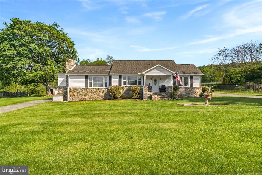 Set on a scenic lot with unbelievable views, this well-maintained home offers the ease of one-level living with additional space to expand in the full basement. The main level features 2 bedrooms, 2 full bathrooms, and a half bath, along with hardwood floors, a beautifully updated white kitchen with Corian countertops, custom blinds, and a spacious laundry/mudroom. The updated bathrooms are stunning, and the living area is highlighted by a fireplace with a gorgeous mantle and hearth.
The attic has been converted into a large private third bedroom, providing flexible living space. Outside, enjoy the cement patio with pergola, greenhouse, shed, and circular driveway—all positioned to take in the incredible mountain and countryside views.
Additional updates and features include a new roof, new furnace, new water pressure tank, 200-amp electric service, generator, and a French drain waterproofing system in the basement with transferable lifetime warranty. The full basement offers excellent storage, workshop space, shelving, pool table area, and future finishing potential.