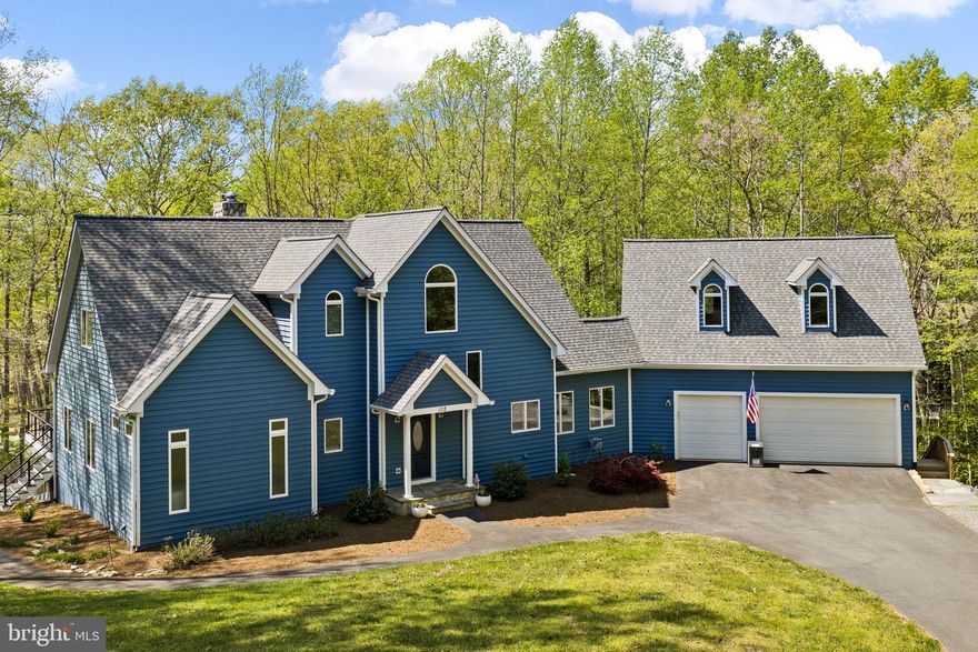 Perfectly set on a very private one-acre parcel at Lake Anna, this recently upgraded waterfront masterpiece truly captures the essence of lakefront living on the public side of the lake, offering a prime mid-lake location in Lakeshore Woods, with over 100 feet of shoreline, a large two-slip boathouse, complete with sun deck and convenient storage room.  Thoughtfully designed for both relaxation and recreation, this completely furnished property invites you into effortless days on the water and peaceful evenings surrounded by nature, with a level of privacy that is increasingly hard to find.  Offered furnished and turnkey—including a golf cart—this home is ready to be enjoyed from day one, whether as a personal escape or a high-performing short-term rental investment. Inside, over 5,000 square feet of thoughtfully designed living space is anchored around a dramatic great room, featuring soaring vaulted ceilings and a wall of windows framing dramatic views of Lake Anna and nature. The renovated kitchen is both upscale and functional, appointed with stainless steel appliances, granite and soapstone countertops, a large gas cooktop with hood, backsplash and fireback, and a generous island designed for gathering. The main level primary suite offers a true sense of comfort with direct deck access, a spa-inspired luxurious bathroom with heated tile floors, a designer tile shower (also with heated floors), standalone soaking tub, double floating vanities, and an oversized walk-in closet with custom California Closet system.  The upper level features two additional large guest bedrooms and a full bathroom.  The finished basement includes a large recreation area  - complete with pool table, foosball table, and double-sided fireplace with mantle - along with three additional spacious bedrooms (one not to code), and another full bathroom.  The outdoor living space is equally inviting, with an expansive deck overlooking the lake, enhanced by new modern cable railing, a beautifully designed hardscape with fire pit for evenings under the stars, and a large two-slip boathouse with recently-service electric boat lifts and a sun deck.   With high-speed fiber internet, an oversized attached garage with unfinished space above for storage or future expansion, and strong rental / investment potential, this waterfront property delivers a rare and powerful combination of comfort, versatility, and lakefront living.  Recent upgrades include a new roof (2024), new HVAC systems (2025 and 2022), and new exterior painting (2024)(see documents section for a complete list of renovations and upgrades recently performed by the sellers).  Location is ideal: five minutes from groceries, local restaurants, The Lake Anna Taphouse, Coffee & Creamery, ABC, vet clinic, nail salon, and more.  Less than 45 minutes to Richmond, Charlottesville, and Fredericksburg, and just 82 miles to our nation's capital, Washington DC.  Investors: short term rentals are permitted here, and this turnkey property is ready to print money.