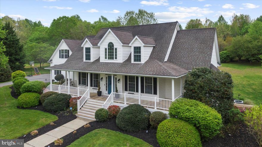 Experience the Best of Country Living at 21 Owensville Road

Welcome to 21 Owensville Road, a stunning custom-built Chaney home set on 3.75 beautifully landscaped acres in the heart of Southern Anne Arundel County. Surrounded by rolling farmland and just minutes from the boating paradise of the West River, this exceptional property offers peaceful country living with easy access to Annapolis, Washington, DC, and Baltimore.

Thoughtfully updated by the Design & Installation Group, this three-story residence offers over 6,000 square feet of refined living space, including a fully finished lower level and a private studio above the garage. From the moment you arrive, mature trees, scenic views, and inviting hardscaped walkways set the tone for the serene lifestyle that awaits.

The sun-filled main level features soaring two-story ceilings and an open floor plan designed for modern living and entertaining. French doors open to expansive front and rear porches, creating a seamless connection between indoor and outdoor spaces—perfect for relaxing or dining while taking in the surrounding natural beauty.

At the heart of the home, the spacious kitchen is an entertainer’s dream with a large center island, generous countertops, cooktop, wall oven, and a bright breakfast area. The main level also includes a recently renovated primary suite with French doors to the back porch, a spa-inspired bathroom with soaking tub, double vanity, and a large walk-in closet. A second main-level bedroom with a private, updated ensuite bath provides additional flexibility and convenience.

Additional main-level highlights include an updated mud and laundry room with custom built-ins, a powder room, a formal dining room ideal for hosting, and a cozy living room centered around a gas fireplace with custom built-in bookshelves.

Upstairs, three generously sized bedrooms share a full bath, complementing the two ensuite bedrooms on the main level. The fully finished lower level offers even more space to live and entertain, featuring a family room, gym, game room, wet bar, full bath, and private walk-out access—ideal for guests or multigenerational living.

The two-car garage provides ample storage and workspace, while the fully finished studio above offers the perfect setting for a home office, creative studio, or guest accommodations.

Outside, the property’s natural beauty continues with a tucked-away gazebo for quiet moments, a large shed for outdoor equipment, and meticulously maintained gardens showcasing vibrant seasonal foliage.

Life in Harwood offers the best of Maryland’s countryside lifestyle—boating, fishing, and waterfront exploration just minutes away—while remaining close to the cultural, dining, and entertainment amenities of Annapolis, DC, and Baltimore.

If you’re searching for a rare blend of serene country living, water access, and city convenience, 21 Owensville Road is truly something special.
Schedule your private tour today.