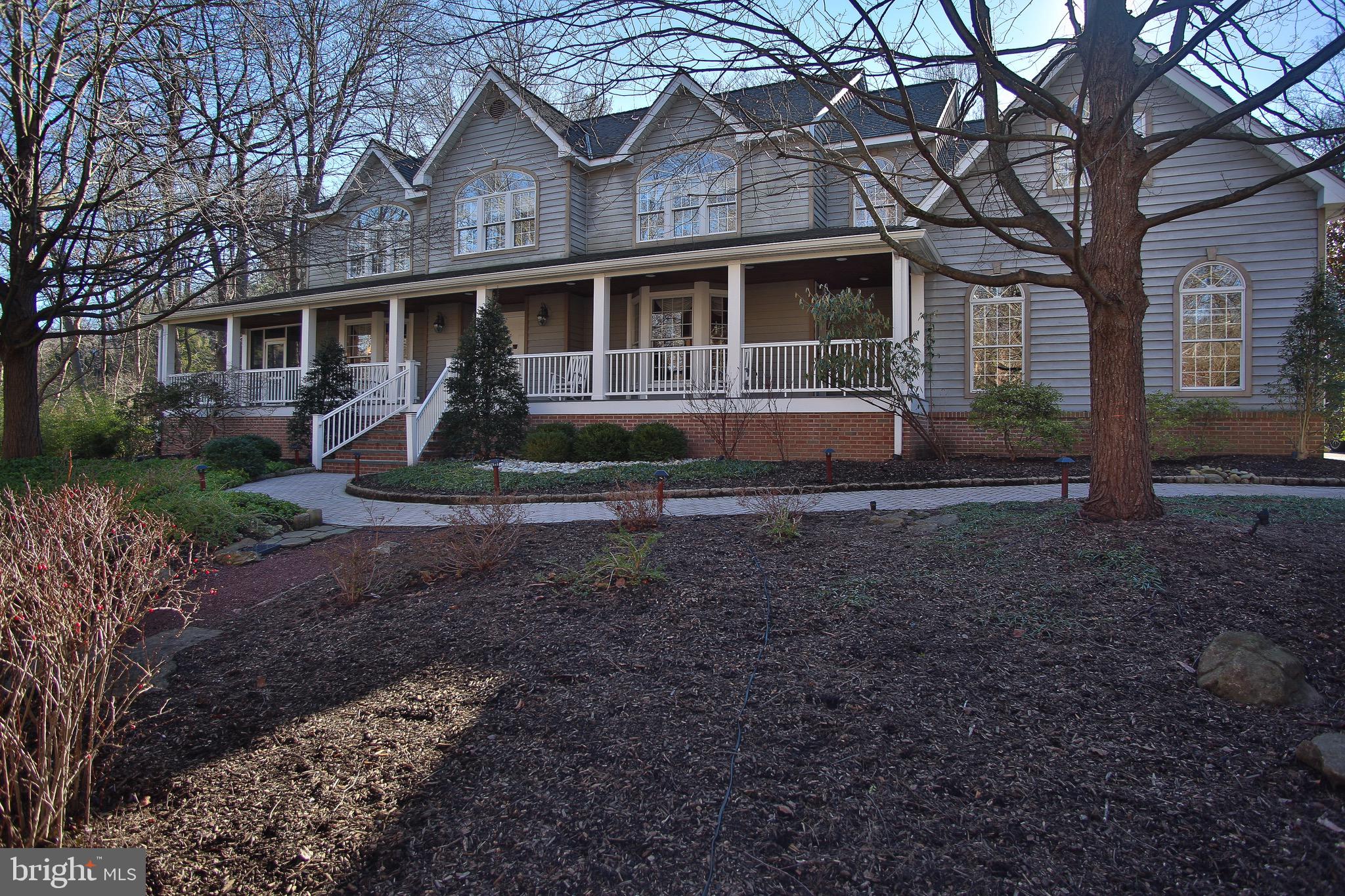 Amazing custom home in a spectacular location, just a short walk to Forbidden Drive and the Wissahickon trails, located in Springfield Township, and minutes from Chestnut Hill. This property offers 4 bedrooms and 2.1 bathrooms in over 4500 square feet, surrounded by mature trees and professional landscaping. The welcoming front porch extends the length of the house and opens to a two story foyer, with hardwood floors and a turned staircase. The main floor offers a fabulous open floor plan, perfect for entertaining and family living. The flexible living room/office with bay window, wainscoting and crown molding can conveniently be closed with custom sliding French door panels. Next to the living room/office is a lovely screened in porch with wood paneled ceiling and wainscoting. The large dining room includes a bay window, chair rail, crown molding and door to the front porch. A game room with bay window could also provide additional office space, playroom or library. The sun-drenched family room features a vaulted ceiling, fireplace, custom built-ins and wet bar, and adjacent breakfast room with skylights both open to the expansive deck and backyard. The kitchen features white cabinets, Corian and granite countertops and a peninsula and center island. A conveniently located powder room and laundry room offer access to both the garage and backyard. The second floor can be accessed by front and back stairs and features a spacious master suite, with sitting room, walk-in closet and master bath with whirlpool tub, stall shower, dual vanity and separate water closet. There are three additional generously sized bedrooms (one currently used as a home gym) and a hall bath. The enormous finished basement offers living space and plenty of storage, including a cedar closet. A large deck with spectacular views and a two car garage complete this very special property. Close to public transportation, shopping and restaurants of Chestnut Hill and King of Prussia and easy access to Center City. Highly rated Springfield School District and many nearby independent schools. One Year Home Warranty. Don't miss this opportunity to own a custom home on one of the most coveted streets in the area!