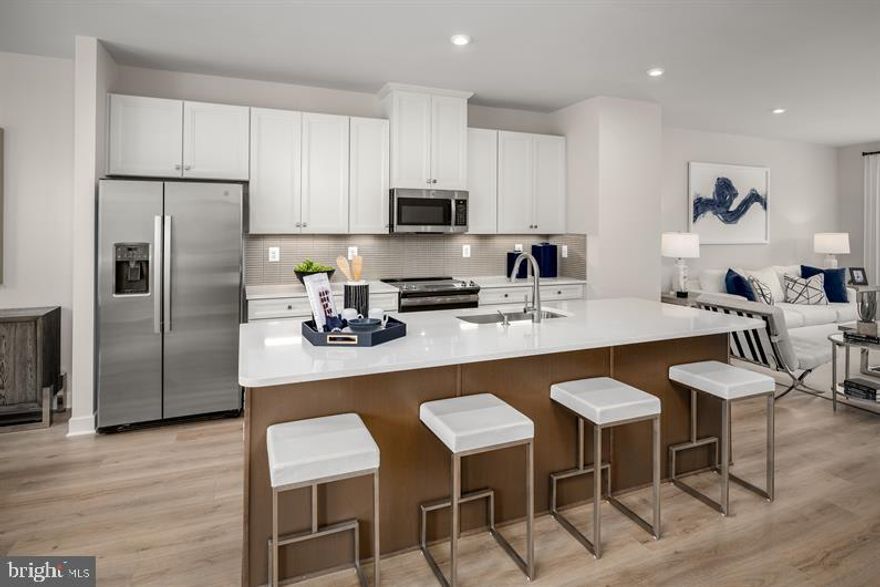 *** ASK ABOUT OUR CURRENT INCENTIVES AND INCREDIBLE CLOSING COST ASSISTANCE ***
The Popular To be built Sonatina. Welcome to Ryan Homes at Wellington Farms, where scenic beauty meets modern conveniences! Wellington Farms is Howard County’s most affordable new construction community in an exclusive, amenity-filled, resort style community located in the heart of North Laurel, MD. We offer a collection of homes that are designed to fit the way you live, making your day-to-day life easier and less chaotic. The convenience of townhome living meets the amenities of a single family home in Ryan’s Sonatina. The sculptural staircase sets the tone of elegant simplicity and functionality that continues through the rest of the home. On the main living level, an enormous Kitchen with island opens onto a bright and airy Living Room, perfect for entertaining. Upstairs are two spacious bedrooms with ample closet space, a hall bath, and a generous Primary Bedroom that features a tray ceiling and a huge walk-in closet. For a truly spa-like experience, the separate Primary Bath features a dual vanity and 5’ shower with dual shower heads. Take advantage of our flexible financing options with NVR Mortgage, which makes closing on your NEW home more affordable than ever. Let us show you the value of new construction and forget the costly repairs and maintenance of an older home, your new home includes a new home warranty, a huge kitchen island, spacious walk-in closets and so much more! Experience the boundless natural beauty of North Laurel and experience everything from shopping, entertainment and dining at restaurants at nearby Maple Lawn. Plus, Wellington Farms Townhomes is a commuter's dream located directly off Rte. 216, 1 mile to I-95, and minutes to Route 29 & Route 32, you’ll have access to an array of recreational activities and many nearby parks. Not only will you be upgrading where you live, but how you live. Come see why you'll love all that Wellington Farms has to offer and schedule your visit today!   Please note:  Lot premiums may apply to some homesites and will apply to End of Group (EOG) homesites.  Other floorplans and homesites may be available. All photos are representative only.