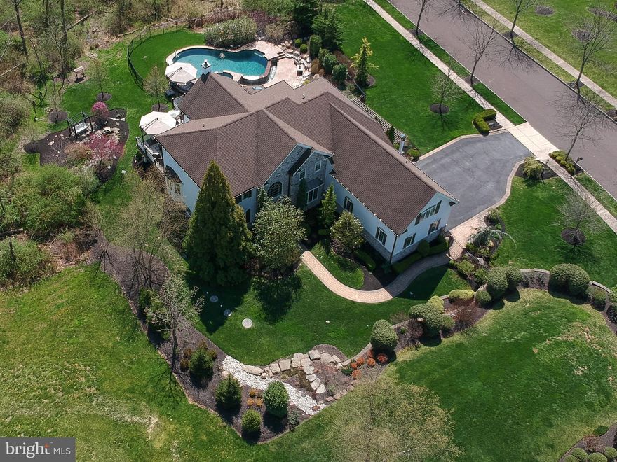 Welcome to 1108 Petrick Place! This one of a kind home has been completely remodeled by the current owners. The new front door opens to the two story foyer, which features beautiful custom millwork by Freedom Millwork, textured wallpaper, and hardwood floors, which run through the first floor. Off the foyer to the left is a quiet office space with a triple window with arched transom. To the right of the foyer is the formal dining room, featuring a tray ceiling, triple crown molding, raised panel millwork walls, and a custom chandelier. Straight ahead from the foyer is the two story family room. The family room has a dramatic stone accent wall, which was added in 2018, along with a propane fireplace, and two french doors, which lead to the composite deck, and strategically placed windows, allowing for a bright and open feel. There is a den off the family room, with recessed lighting and two bay windows. The kitchen and breakfast room were completely renovated in 2021, and features quartz countertops, custom cabinetry with low voltage under counter lighting, a large island with oversized Circa pendant lighting and seating for 4, a hidden coffee station, a prep sink, and a Shaw farm-style apron sink.  State of the art appliances include the sub-zero refrigerator, Wolf double wall oven, food warmer, and 6 burner gas stove, a Hoshizaki ice maker, 2 dishwashers (Bosch and Beko), and an undercounter Sharp microwave. The kitchen opens to the breakfast room, which has recessed lighting, stunning white oak exposed beams, and built-in cabinets and drawers with a quartz countertop. There is a barn door leading to the rear staircase. The sunroom is off the breakfast room, and has a vaulted ceiling, gorgeous wallpaper, recessed lighting, and a door to the deck. The first floor also includes a powder room, a large walk-in pantry, and an oversized laundry/mudroom with washer and dryer, two closets, cabinets and a countertop, and a sink. 
Upstairs, double doors open to the primary suite, which was fully renovated in 2016. As you enter, you will immediately notice the wide plank wood flooring and extra height baseboards. There is a sitting room/office/nursery located off the entrance hallway. The bedroom has an accent wall of raised panel millwork, triple crown molding, and a barn door that opens to the decadent dressing room. The dressing room has custom lighting, a built in vanity, and four walk in closets. The primary bath has a hidden toilet, double vanity separated by glass panel front cabinets, a large soaking tub, and an oversized stall shower. There is a junior suite with neutral carpet, walk-in closet, and a full bathroom with an oversized stall shower. Two more bedrooms, both with neutral carpet and double closets, share a full bathroom with countertop sink, custom cabinets, and tub/shower combo. The finished walkout basement provides another entire level of living space, with a full kitchen, bedroom, and bathroom. The custom millwork, a highlight throughout the home, continues in the basement. There is a sitting area, media area, and game area. The fieldstone accent wall frames a propane fireplace. The walkout ground level exit has built-ins and french doors leading to the pool and patio. The saltwater pool has a spa and waterfall accents. The area surrounding the pool provides plenty of room to spread out and relax, or entertain! Another area of the back yard features a bench swing overlooking a Koi pond. Steps lead up from the pool area to the 600 square foot composite deck. From the driveway, enter the three car garage, follow the paver path around to the front door, or in the other direction, under the pergola covered walkway to the gate leading to the pool area. Professional landscaping and hardscaping make the exterior feel like an oasis. The home has a 20kw Generac whole house generator in the event of a power outage. Everything in this house has been done with exquisite attention to detail - all you need to do is move in!