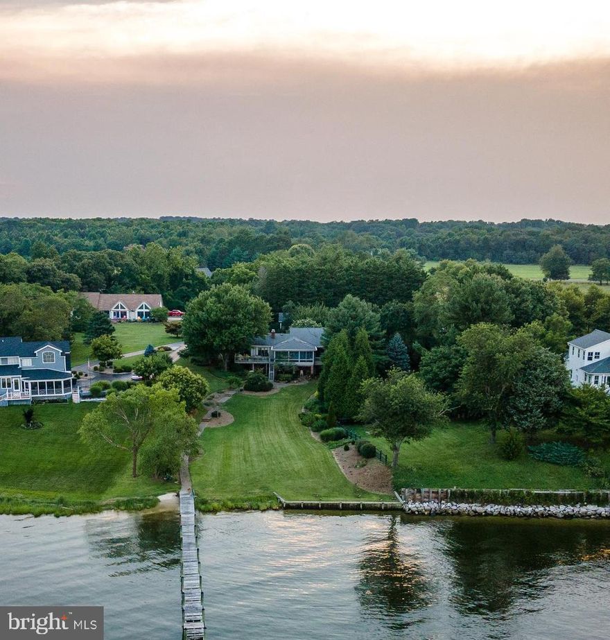 Patuxent river waterfront  with panoramic views across to Solomon's Island.  Custom built home with original owners.  2 x 6 construction w/ added  insulation, Anderson windows.  Great room has high arched ceilings, hardwood floors & custom stone wood burning fireplace built by well known stone mason.  Large kitchen has 2 tone cabinets, granite counters, stainless appliances, island & breakfast bar.  Sunroom Has beautiful water views of the Thomas Johnson Bridge.  Master bedroom bath & Kitchen were remodeled.  Siding was replaced 4 years ago  & gutter guards added.  HVAC w/ humidifier was replaced in 2018 & has a 98% efficiency rating.  Lower level has two bedrooms, full bath, family room, storage room & large work shop.  Paver patio, brick walk ways.  Natural gas line.  Beautiful grounds (property used to be an orchard years ago.) Potting shed.  Pier has electric, water & lift.  Small beach area.