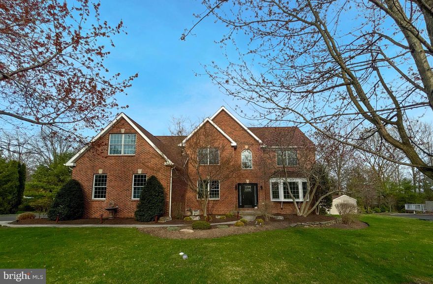 Tucked away on a peaceful cul-de-sac in desirable Oak Tree Farms, this stunning 5-bedroom Colonial is the definition of move-in ready luxury. Completely reimagined from top to bottom, every inch of this home showcases impeccable craftsmanship and modern elegance. Step inside to modern plank hardwood floors and a dramatic two-story foyer that sets the tone. A private office with custom built-ins makes working from home a dream, while the sun-drenched living room—with its beautiful bay window—offers the perfect place to unwind. Entertain in style in the spacious formal dining room or gather in the show-stopping gourmet kitchen featuring granite countertops, a center island, sleek white cabinetry, high-end appliances, and designer finishes throughout. The open-concept family room impresses with soaring cathedral ceilings, skylights, and a cozy marble-accented fireplace. A convenient first-floor bedroom adds flexibility for guests or multi-generational living. Upstairs, retreat to the luxurious primary suite complete with a custom walk-in closet, private sitting area, and also its own library. The spa-inspired en-suite bath is pure indulgence, boasting dual vanities, elegant tilework, a rain shower with body jets, heated towel rack, and upscale finishes that rival any resort. The fully finished lower level offers endless space for entertaining, relaxing, or recreation. Outside, enjoy summer evenings on the beautifully designed paver patio to gather around the fire pit or sit on the tree swing and enjoy the park like setting.  With a brand-new roof and HVAC, an included additional parcel of land, and a prime location near major highways and within the Pennsbury School District, this home truly has it all. Skip the wait for new construction—your dream home is here and ready for you.