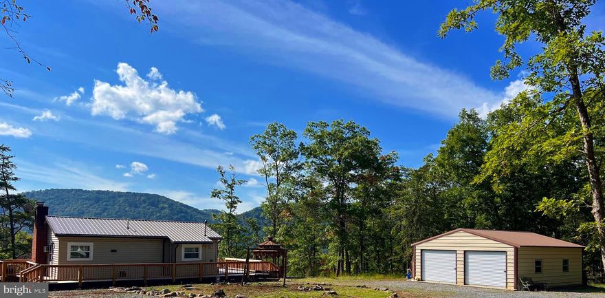 The perfect retreat for enjoying views, river life, hunting and the outdoors! This has it all and is turnkey with all furnishings!  Perfect investment cabin  or downsize and make it your full time residence!  Has all the amenities; water, septic, electric, internet and cell service. Over sized garage, gazebo , wrap-around deck and fire pit for plenty of outdoor fun and entertaining. The pictures don't do it justice. It has a new metal roof, new vinyl siding and windows, new gutter/gutter guard, new wrap around deck, new French doors w/interior blinds, new water filtration system.  House and garage sit on 3.23 wooded acres and you will also be joint owner in the POA Community Access 3.09 gated acres on the South Branch of the Potomac River with pavilion,  picnic tables and  private steps down to river, known famously as "The Trough",  renowned for some off the best bass fishing you'll find in WV! This is adjoining Stoney Run Fishing and Boating Access to make unloading and loading your canoe or kayak even easier! And, no direct access from Little Mountain Estates, but Nathaniel Mountain Wildlife Management area lies to the east, less than a mile away by the way the crow flies! . Less than 15 miles from Corridor H/Rt. 48 to access skiing, biking and hiking  Canaan Valley, just an hour away. Put a steak on the included grill, and enjoy the setting sun from the deck bar or enjoy the view from the gazebo with your morning coffee each day! Don't let this one pass you by when it's affordable and only a two hour drive from NOVA!
