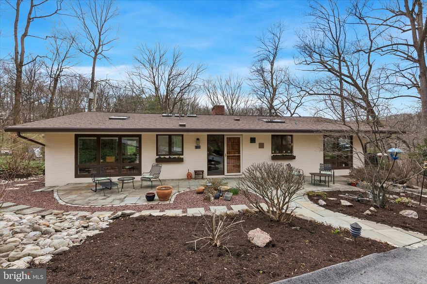 Set on a private lot, in a quiet cul-de-sac, yet in the heart of booming Wayne, 610 Arlyn Circle is an extraordinary contemporary residence designed and built in 1958 by legendary builder Robert McElroy. With its wooded backdrop and rare privacy, the property embodies the qualities McElroy championed throughout his career: architecture that grows from its landscape and invites daily life to flow in rhythm with nature. 
McElroy, a true pioneer of contemporary design from the late 1950s through the 1970s, crafted homes along the Main Line known for their dynamic rooflines, expansive floor-to-ceiling glass walls that invite sunlight and views, vaulted ceilings, and exposed beams—all optimized for hillside privacy and harmony with the land. 610 Arlyn is no exception. There is a reason the same owners occupied the property for 53 years! The home has been lovingly maintained and meticulously cared for throughout the years and it truly blends timeless design with comfortable everyday living.
The main level features a bright and airy living room, with a wood burning fireplace and overlooking a serene nature of the backyard; a welcoming and spacious dining area, and a kitchen with ample wood cabinetry and workspace—perfect for both daily living and entertaining. Generously sized 3 bedrooms and 2 well-appointed full baths provide comfort and functionality throughout the home and are located on the same level. An additional 4th bedroom and a full bath are located on the lower level next to a cozy family room with a wood burning fireplace, also overlooking tranquil views of the backyard. Ideally located in a highly desirable Main Line neighborhood, and in one of the best school districts in the entire country - Tredyffrin/Easttown SD! For food shopping, within 1-2 miles are the Wayne Farmers Market, Trader Joe’s, Whole Foods, Wegmans, or ACME. Less than a mile away is the Strafford station on the Paoli/Thorndale SEPTA regional rail line. Every imaginable retail store that you can think of is less than 3 miles away at the various locations in King of Prussia. All of the independent and boutique retail stores and restaurants along Lancaster Avenue in Wayne are just a 5 minute drive as is access to the PA Turnpike, Route 202 & I-76 for commuting in any direction. Within 2 miles there are also the Chester Valley and Radnor rail trails. Valley Forge National Historical Park is less than 10 min drive away. Superb location, yet tucked away in your own wooded oasis, come explore this Mid-Century Modern gem at 610 Arlyn Circle!