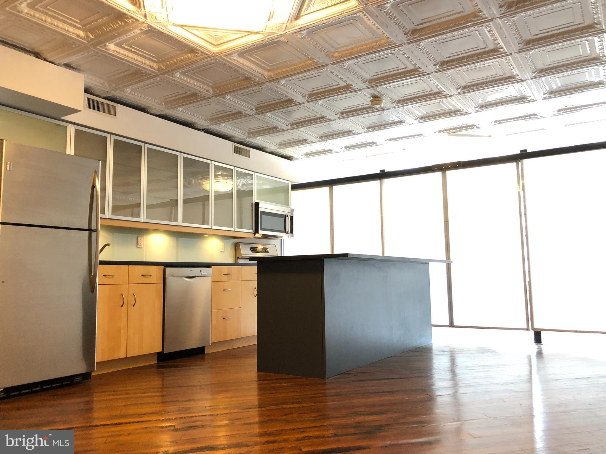 Stunning 20' wide by 70' long custom loft in heart of Old City offering 2 bedrooms & full bath with in unit laundry!! This wide open living space with original pine hardwood floors under the original tin ceiling creates a beautiful & unique living space. Contemporary Chef's kitchen w stainless appliances & breakfast bar is prime for hosting guests in an amazing atmosphere. The tiled bathroom has tub/shower, washer/dryer, & glass ceiling to let natural light drench you. Wired for cable & internet. The Private Outdoor Space adds several hundred square feet of open air living PLUS a shared roof deck w stunning 360 views include Ben Franklin Bridge, Christ Church, & Center City Skyline...all filled w firework displays on July 4th & NYE! Other units in this well managed boutique building offer considerate people - a real community. The location is unbeatable for transportation, amenities & restaurants. This loft is an amazing space & a Must See!!!