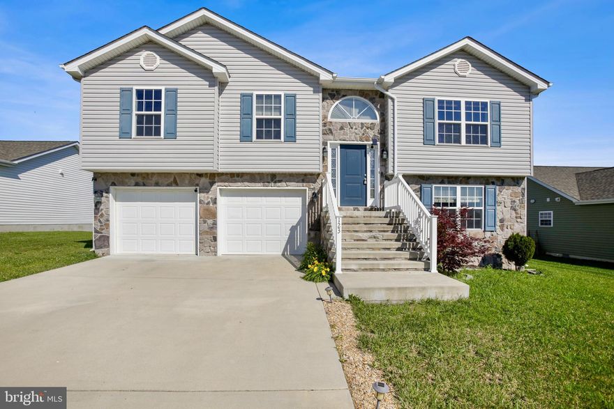 Welcome to 123 Obadiah Drive, a 3-bedroom, 3-bath split foyer home built in 2019, offering over 1800 square feet of finished living space across two thoughtfully designed levels in the quiet Heritage Hills community of Martinsburg. With a bright, open layout and timeless interior finishes, this home offers the perfect blend of modern comfort and everyday functionality.

The upper level features vaulted ceilings and hardwood floors that enhance the spaciousness of the main living area, where a natural gas burning  fireplace adds warmth and character. The adjacent eat-in kitchen is well-appointed with granite countertops, stainless steel appliances, and ample cabinetry, with plenty of space for a full-size dining table. Just off the kitchen, a large deck provides the perfect setting for outdoor dining, entertaining, or simply enjoying a peaceful morning outdoors. Down the hall, the private primary suite includes a walk-in closet and an attached full bath, while two additional bedrooms and a second full bath offer comfortable accommodations for family or guests.

The fully finished lower level adds versatility with a spacious family room, a full bath, and a multipurpose den—ideal for a home office, gym, or guest area—offering flexibility to meet a variety of needs.

Located in the established Heritage Hills neighborhood, this home enjoys a quiet residential setting with community sidewalks and open green space, just minutes from local conveniences. Nearby favorites include Boyd’s Steakhouse, U.S. Fish & Brew, and Blue White Grill, with outdoor recreation available at War Memorial Park and Poor House Farm.

For commuters, the home offers easy access to I-81 and Route 9, and is just a short drive from the MARC train station for direct rail service to Frederick, Rockville, and Washington, D.C. Dulles International and Hagerstown Regional airports are also within reach, providing convenient options for both regional and long-distance travel.

Combining a modern build, flexible layout, and a location that connects you to both nature and city access, 123 Obadiah Drive is ready to welcome you home.
