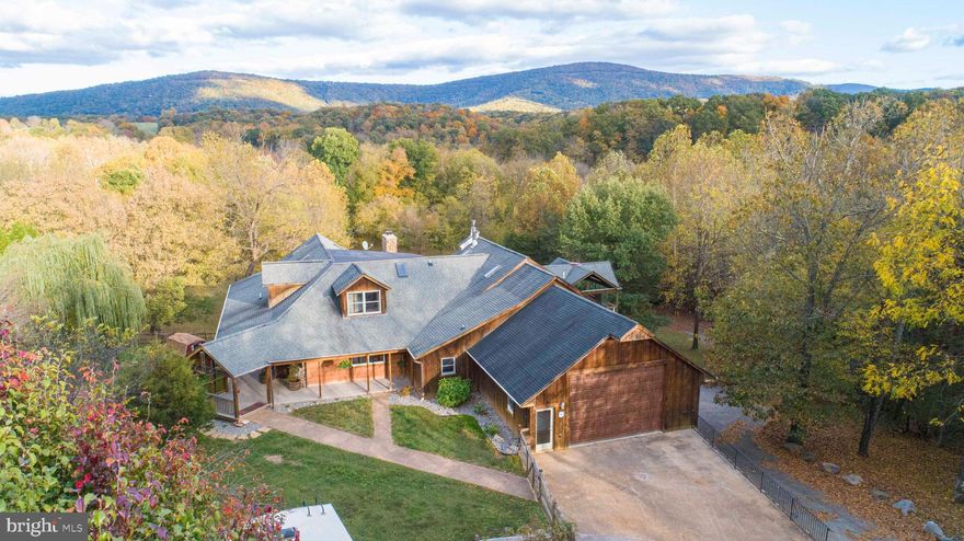 RIVERFRONT!  Beautiful one-of-a-kind custom built RIVERFRONT home with breathtaking mountain views and views of the Skyline Drive.  Enjoy year around sunrises & endless rainbows over the Shenandoah River.  This lovely unique home offers 5,523 finished sq. ft., 5 bedrooms and 4 ½ Baths on 5.08 private & secluded (park like setting) acres, with 438 feet of river frontage.  Additional rooms can be used as bedrooms although they are not official bedrooms This custom home offers two beautiful stone wood burning fireplaces, pellet stove, local custom cut white pine beams, skylights, wood floors, commercial grade appliances, upgraded counter tops, and a glass wall staircase trimmed in red cedar.  Huge great room, fully open floor plan with kitchen, large dining area to accommodate table and seating for 15 or more, wet bar, perfect for entertaining family & friends complete with kegerator, mini refrigerator & sink, open to family room, with stone fireplace, soaring cathedral ceilings & endless windows, where you never have to miss a view or sunrise.   Luxury main level master suite with local custom cut and milled red cedar ceiling & trim, red cedar custom shelving, woodstove, natural stone tile in master bedroom, custom master shower and jacuzzi tub to soak in the views.  Upper level offers 3 (unofficial) additional bedrooms, & one full bath.  Three secret hidden rooms, locations to be disclosed.  Enter thru the dungeon style door to the fully finished lower level, perfect for an in- law suite, with separate entrance.  Lower level offers recreational room, family room with stone wood burning fireplace (ready to be converted to gas), 3 (unofficial) bedrooms, and full bath.  If you love the great outdoors and love to entertain, there’s tons of additional space on the large wrap around decking with hot tub and porches.  Enjoy covered porch with additional covered outdoor room, and two flagstone patios.  Decks and porches are composite with western cedar handrails with ½ inch tempered glass panels.  2x6 exterior walls, western cedar on all exterior siding and trim, solid wood doors on the interior and exterior.  This home was built so the exterior is nearly maintenance free.  You will love the two fishponds, one with fountain. Barn on property with electricity and filtered running water, and chicken coops.  Custom formed concrete driveway and 5 car garage, 2 car on main and 3 cars on lower level, main-level garage loft with electricity and access to master bedroom, is ready to finish, newer thermal garage doors installed, with workshop area, and additional storage areas.  Gather the family and friends at the river pavilion complete with electricity & filtered water perfect for entertaining.   Brick pig roast, fire pit to roast marshmallows or just sit and relax by the fire.  Cut in boat ramp to the river on property, perfect for launching your boat or canoe.  Enjoy hours on the river, boating, canoeing, kayaking, floating, and fishing.   Over 5 acres to roam, beautiful park like setting on the river, tree house for kids, and plenty of room with unlimited future possibilities.  Property is located on a dead-end street with only three other houses for extra privacy.  Comcast/Xfinity high speed internet is available for those who work from home.  A short distance to town, Skyline Drive, Andy Guest State Park, hiking trails, wineries, golf courses and to I-66 for commuters.  It’s all here! A world away from it all, yet minutes to everything.  Generator to convey