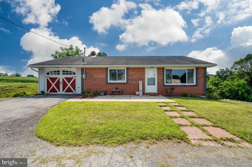 Enjoy peaceful country living in this 3 Bed, 2 full Bath rancher in Wilson Schools.  Perfect for first time Buyers and downsizers, alike.  A night relaxing on the deck and you'll be hooked.  Also a great yard and 1 car garage.  Open Living/Dining/Kithcen area and two beds and full bath on main level.  Lower level offers addl bedroom or two - flexible layout.  One room currently used as a huge walk-in closet.  Walk-out lower level to the patio.  From Upstairs the deck overlooks the yard and land beyond.  Plenty of parking and space to grow.