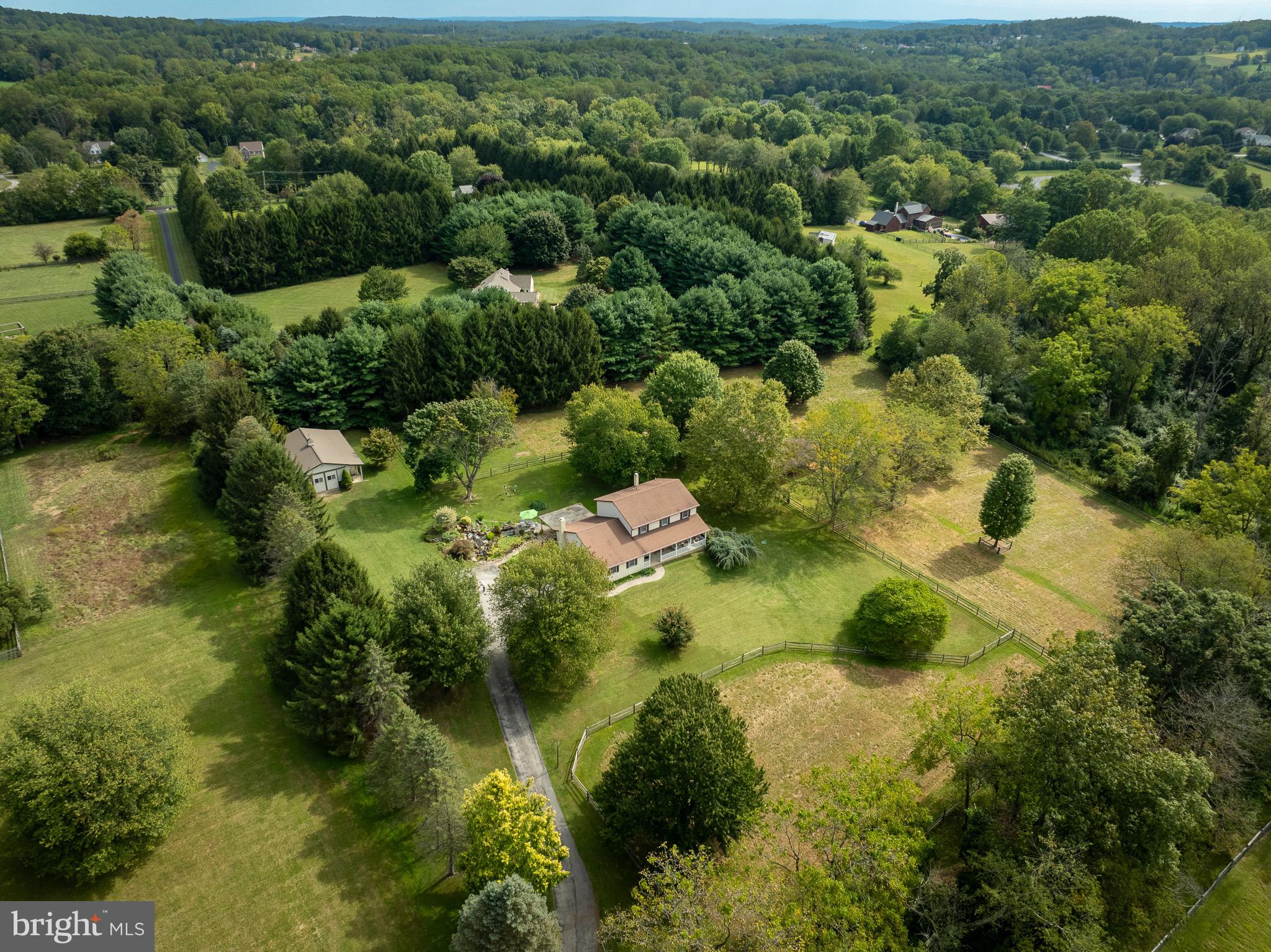 Nestled at the end of a long driveway, this secluded 4-acre property offers the perfect opportunity to enjoy tranquility and unwind as well as owning a farm with horses or other livestock. 1324 Fairview Road is located in East Nantmeal Township of Chester County and in the sought after Owen J Roberts School District. The 3-bedroom, 2.5-bath home features spacious living areas, natural sunlight throughout, a kitchen with new quartz countertops, large primary bed and bathroom with brand new carpet in the primary suite and hallway/stairs. In the basement you will find additional storage, laundry/mudroom , walkout door towards the barn and a flex room that could serve as an art studio, workout room or more! Step out the front door and you will have a peaceful porch with views of your fields and walk out the back door to a lovely patio with a large koi pond and waterfall, overlooking sweeping green pastures from every angle. One of the true highlights of the property is the well maintained 3 stall barn with a tack room (hot and cold water)—ideal for horses or other livestock. As well as the oversized barn for storing your trailer, trucks and tractors. Whether you're dreaming of a hobby farm, an equestrian escape, or a private sanctuary, this unique property offers the space, setting, and charm to make it your own.