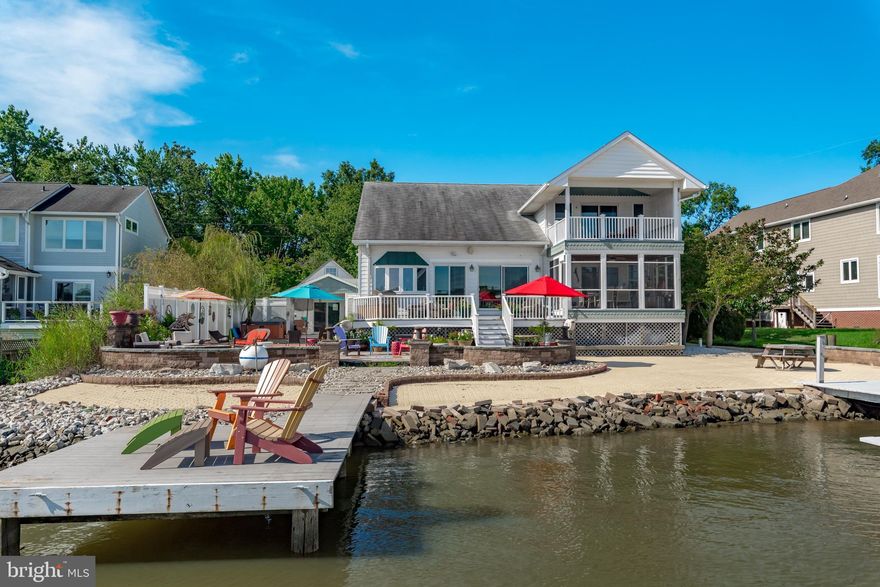 **Appraisers** See Agent Private remarks in MLS for details.**  Waterfront and Sunrise enjoyment defines this eclectic cottage on Fishing Creek!  Entertain to your heart's desire and take a dip in your private pool while enjoying activity on the water.  Four-plus feet of deep water on Fishing Creek allows you to have larger boats at your dock.  There are three lifts and multiple slips for a variety of vessel sizes. The boathouse has a newer (2019) roof with leased solar panels. There is a home office  and workroom in the boat house in addition to the covered lift. Everything about this waterside of this property is designed for enjoyment of The Chesapeake Bay! This home connects the charm of a 1940s cottage to a 2004-built, vaulted, great room with wide plank Koa flooring, a floor-to-ceiling gas fireplace, a chef's stove and visual enjoyment of the water from every corner. One main level primary bedroom and a second primary bedroom suite on the upper level.  Rooms for two home offices in addition to four bedrooms and four full baths.  Workroom and laundry on main level.  Custom, curved stair case welcomes you to the primary suite and home office on the upper level. Additional storage in upper level closet and large walk-in closet. Two car garage with storage above it  and covered entry to home.  Side driveway with parking for at least eight cars. Oakwood Community has a voluntary HOA fee of $50/ year with neighbors enjoying frequent trips to Thomas Point Park and seasonal wildlife.