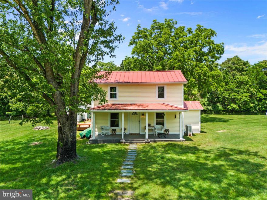 RIVER FRONT!!! A rare opportunity to own a beautifully renovated farmhouse on 15 acres with approximately 850 feet of frontage along the South Fork of the Shenandoah River. This charming home features three bedrooms, two full baths, a durable metal roof, a welcoming front porch, and a spacious rear deck—perfect for enjoying the peaceful surroundings. The property offers a large, level yard, approximately 13 wooded acres, and walking paths that wind through the trees, leading to a cleared area by the river—ideal for relaxing, fishing, or launching a kayak. With stunning Blue Ridge views, this quiet retreat is just 10 minutes from town conveniences like dining, shopping, and Massanutten Resort. Harrisonburg and James Madison University are only 20 minutes away, while Merck and Coors are just a five-minute drive. A perfect blend of country living and modern convenience.