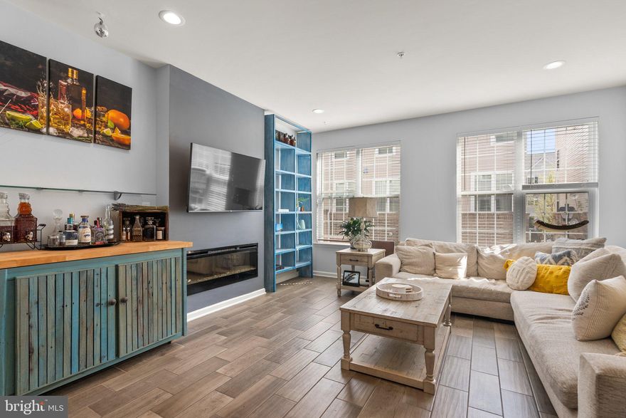 You will fall in love with this beautiful brick open concept four story townhome with a two car garage. Designed for entertaining and easy living, the main level is bright and airy with tall ceilings, recessed lighting, and wide planked wood floors. The heart of the home is the gourmet chef’s kitchen boasting plenty of cabinets, stainless steel appliances, granite countertops, five burner gas range, double oven, and an elongated kitchen island for flexible dining and entertaining.  The kitchen is flanked on each end by a spacious living room and dining area.  The main level is completed by a half bathroom conveniently tucked away.  Journey up to the first upper level which hosts 2 sizable bedrooms sharing a hallway bathroom and a cozy den space that could be used as a TV room or an office space. The primary suite on the top floor is a peaceful retreat complemented by a private balcony, a large walk-in closet, and an en suite bathroom with dual sinks and separate shower and tub. Easy access to Washington, D. C. and the 495 beltway to Virginia or Silver Spring, route 214 east and west and route 202 north and south.