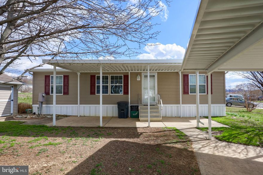 Are you ready to enjoy life in Lancaster’s Southern End? This three bed, two bath home is in a quiet  community surrounded by agricultural land. The park features a community pool for your enjoyment through the summer. The home is outfitted with a generous kitchen and tall ceilings. The skylights add to the available light. The primary bedroom has its own bathroom and shower. Cross the open living room and you have two more bedrooms and a separate full bath. Comforts are provided by natural gas and central air. Park your car under the double carport, avoiding the hot summer sun or clearing the snow off of it in the winter, you have the added benefit of not having to unload the groceries in the rain. If this is the lifestyle that you are looking for, stop by and see what this home has to offer!