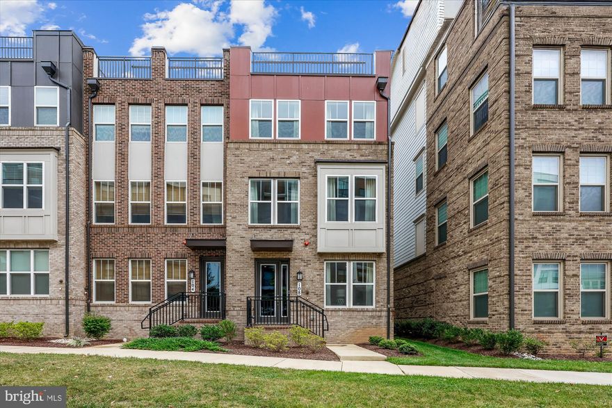 Experience luxury living in this exceptional 4-bedroom, 4.5-bath end-unit townhome offering approximately 2,599 sq ft of beautifully curated space in the heart of Crown Farm. Built with modern sophistication in mind, this home blends contemporary design, premium finishes, and unmatched convenience.  Perfectly positioned just moments from Downtown Crown and Rio, this residence offers effortless access to upscale dining, vibrant cafés, boutique shopping, and scenic lakeside walks. Commuting is seamless with immediate access to I-270 and a quick stroll to community amenities, including a pool and clubhouse.  Step into a light-filled, flexible entry-level layout ideal for a private office, fitness studio, or lounge, complete with a full bathroom and shower on the first floor. 
The main living level showcases a modern kitchen with an expansive quartz island, stainless steel appliances, and abundant cabinetry , an open-concept layout with a sophisticated dining space and a welcoming living room centered around a gas fireplace , paired with a well-placed half bathroom for everyday ease.  The third level features three bedrooms, including a primary suite with a walk-in closet, two modern full baths, and a conveniently located laundry area with a premium, high-efficiency 2-in-1 washer/dryer that stays with the home. This all-in-one unit is designed to wash and dry in a single cycle, allowing you to step away without worrying about transferring wet laundry. 
Ascend to the fourth level to discover a private retreat—complete with a bedroom, full bath, bonus living area, and an expansive rooftop terrace. This elevated outdoor terrace is perfect for unwinding and hosting intimate gatherings. This house is complete with a full sized 2-car garage which is EV ready with professional wiring for two chargers. This home captures the best of luxury, comfort, and convenience, surrounded by exceptional shopping, dining, and entertainment in one of the area’s most desirable communities.