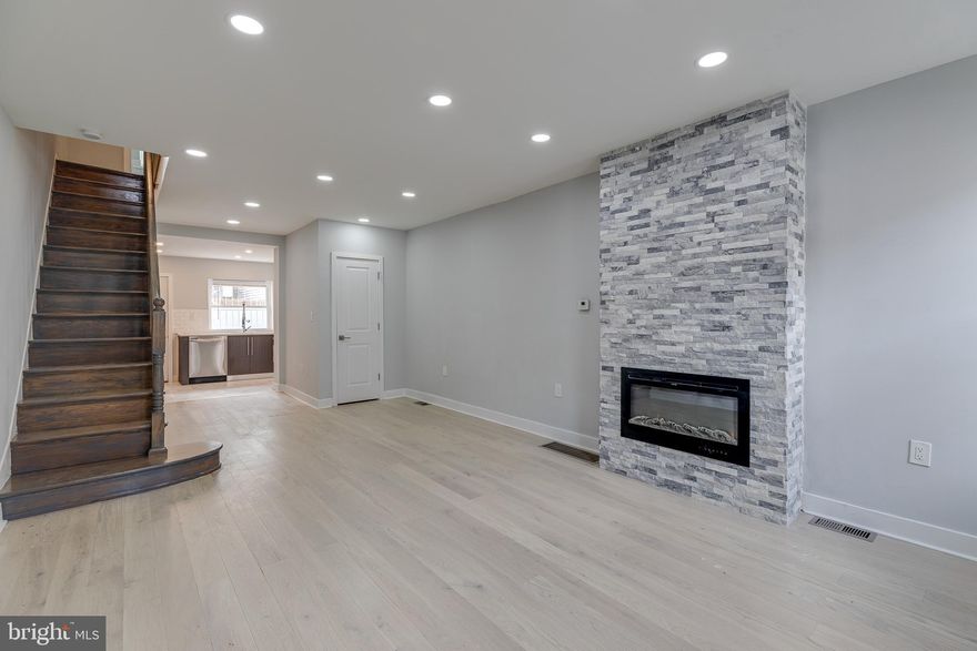 Welcome to 1914 McClellan St! This beautifully rehabbed 2 bed, 1.5 bath row home is situated on a nice and quiet block in desirable Point Breeze. When you enter the property, you are met with an open-concept layout with natural light filling the space! The custom stonework around the electric fireplace brings a chic and stylish element to the living room, making it a perfect centerpiece.! The small half-bath is perfect for guests; with stylish features, this small space truly makes a statement. The nicely sized kitchen features an array of modern features: stainless-steel appliances, granite countertops, dual-toned cabinetry, a gas range, and a wide basin sink with a faucet set for a chef! Directly through the kitchen you will find the quaint backyard space with plenty of room for a backyard barbecue with friends and family!  Up the custom stained staircase, you are met with the full bath featuring a luxurious tub, glass enclosed shower, updated toilet, and a double vanity sink with all modern features! Finally, the two bedrooms feature hardwood like flooring, plenty of natural lighting, and nicely sized closets! This property is not to be missed