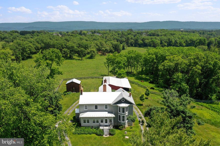 Welcome to The Farm at Clover Hill!  72 Acre Farm | Historic Farmhouse Circa 1781 | Successful Airbnb | Flower Business Building & Crops | Ice House | Corral | Barn |  General Development Plan for subdivision (11 house sites.)  Unique opportunity to purchase land that does not have a conservation easement in the Rockland area! Have you dreamed of owning a farm and living in a historic farmhouse in Virginia?  This could be the perfect property for you!  OR would you like to build your dream house with gorgeous views of the Blue Ridge Mountains, while running a successful Airbnb and flower farm?  Or would you like to own enough land to build an additional home or two for family?  How about running a breathtaking wedding venue? There are endless possibilities at The Farm at Clover Hill!!
Currently cattle are run on the farm.  There is a barn, corral, feeders, hand dug well that waters the cattle, and 8 bay shed.  There is fencing in place to keep cattle safe.  The gorgeous historic farmhouse has been renovated and updated.  It has been running as an Airbnb for years (the 6th Airbnb approved in Warren County!)  The new owners can chose to live in the farmhouse or continue the business!  Behind the house is the "ice house."  This building was built to resemble the original ice house.  It can be used for events as a gathering space, perfect for cocktails at sunset!  There is a large 19 x 13 deck to enjoy.  Sellers had a vision to expand into a wedding venue.  Currently, there has been 2 conditional use permits approved for this property.  1. Events, to include flower shop. 2. Short term vacation rental.  New owners would need to reapply. FARMHOUSE: Enjoy a cheerful enclosed front porch as you first enter!  MAIN LEVEL: The main level has been updated, painted, and restored.  There is a large parlor/den perfect for relaxing and playing a round of cards in the evening.  Also on the main level is comfortable library/living room with books the owners found in the attic!  There are numerous sets of step to the upper level throughout, total of 3. The kitchen, formal dining room, and utility room/laundry room will not disappoint.  The kitchen has stainless steel appliances, island, sitting area with gas fireplace, and modern conveniences. The main floor also has a full bath and half bath.  UPPER LEVEL: Four spacious bedrooms are on the upper level.  Multiple sitting areas create a perfect space for potential wedding preparations and parties.
BUILDING OPTION: There has been general development plan designed for 11 house sites on this property.  See plat in view docs. Property is zoned rural residential.
FLOWER BUSINESS: The building used as the flower shop is 19x13 inside with a covered porch (with ceiling fans) 19x13.  There are fields of herbs and flowers with electric fence for protection.
GOLF COURSE ACCESS: Property is close to three top golf courses in town.  Within one mile enjoy Bowling Green Country Club, Shenandoah Golf Club, and Bowling Green South Golf Course.
CLOVER HILL HISTORY: 1781 Two story Log Home on Clover Hill mentioned in the deed. 1820 Federal Style (Front brick section) added. 1850-1890 Queen Ann section added.  See view docs for more details.