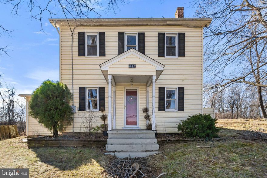 Flanked by old oaks, this 1891 farmhouse welcomes you with classic buttercream paint and black shutters. Sitting pretty on a generous 1.59 acres, it’s surrounded by pleasing views yet still close to town, giving you the best of both worlds. Inside, modern updates bring a clean aesthetic while still leaving the character of its architectural history. The paint choices, hardwood floors, fireplaces, and pops of old-school hardware truly elevate the living experience. The kitchen is the perfect example, combining a conversation-piece fireplace with complimentary shades of green on the walls and cabinets, stainless steel appliances, and a center island/eat-in table. A comfortable living/family room, sizable dining room with brick fireplace, bedroom, full bath, and laundry room also comprise the main level. The other two bedrooms are upstairs,
including the expansive primary suite, which not only includes a beautiful full bath and walk-in closet, but a sizable bedroom and a handsome sitting area with exposed beams. A quaint deck overlooks the back yard with plenty of space for gardening, firepits, kid’s activities, and more. There’s also a shed for storing your outdoor essentials. Don’t let this quintessential charmer slip by!