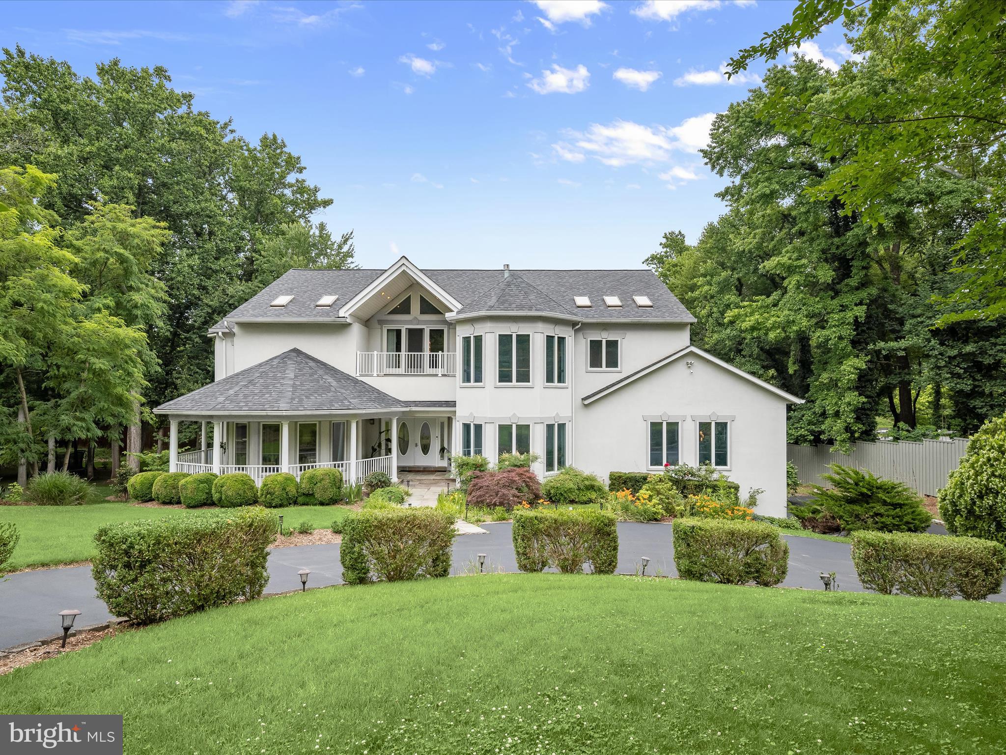LISTED BELOW APPRAISED VALUE ( $1.95M) Discover the ultimate in comfort, luxury, and craftsmanship in this custom-built, one-of-a-kind contemporary home, thoughtfully designed and meticulously maintained by its original owner. Sited on nearly an acre in the sought-after water-privileged Severn View community, this exceptional property offers over 9,000 square feet of finished living space, six bedrooms, four bathrooms, a deeded boat slip, an in-ground pool, and a show-stopping outdoor kitchen with a wood-fired pizza oven, perfect for entertaining in every season. Tucked away in a serene yet convenient location, the Severn View community marina offers kayak storage, a fire pit, and a community gazebo, picnic area, and play area along Asquith Creek.
A circular driveway and beautifully landscaped grounds create a grand first impression, enhanced by a stone walkway and a charming wraparound front porch. Step inside the dramatic two-story foyer, where a soaring cathedral ceiling, glass railings, and marble accents set the tone for the home's modern elegance. Engineered hardwood flooring flows through much of the main and upper levels, complementing the neutral color palette and expansive windows that flood the interior with natural light. Designed for both grand entertaining and comfortable living, the main level features elegant formal living and dining rooms with a built-in buffet and sliding glass door to the porch. The gourmet kitchen is a chef’s dream, outfitted with crisp white cabinetry, roll-out shelving, stainless steel appliances including a Sub-Zero refrigerator, island, breakfast bar, casual dining space, planning station, and walk-in pantry. Just off the kitchen, the cozy family room centers around a dual-sided fireplace shared with the breathtaking great room, an expansive space perfect for hosting large gatherings. A main-level den offers a quiet space to work from home, while a bedroom and full bath provide added flexibility for guests or multigenerational living.
Upstairs, the primary suite is a luxurious retreat complete with hardwood flooring, skylights, a private sitting room with a dual-sided fireplace, and a custom walk-in closet with built-in organization. The spa-like en suite bath with marble tile, double vanity, soaking tub, and a multi-head spa shower. 3 additional generously sized bedrooms, a full bath, laundry room, and access to an upper-level balcony complete the floor.
The lower level is a true entertainment hub, boasting tile flooring, walk-out access to the backyard, and garage entry. Movie lovers will be thrilled with the state-of-the-art home theater, featuring elevated seating, high-end audio and visual equipment, acoustical wall panels, and dimmable lighting to create a true cinematic experience. A spacious recreation room, 6th bedroom, and beautifully renovated full bath round out the level, with ample storage throughout.
Step outside to your own private resort. The expansive composite deck overlooks a lush rear yard and wooded backdrop. Enjoy warm summer days in the in-ground pool, evenings around the custom fire pit with built-in seating, and weekend gatherings at the outdoor bar and kitchen, fully equipped with a grill, refrigerator, and pizza oven. Additional highlights include a three-car side-loading garage with 9’ doors, storage shed, established raised garden beds, whole-house generator, and rear fencing.
This home was built with Polysteel Insulating Concrete Forms (ICFs), offering superior energy efficiency, noise reduction, safety, and durability. Recent updates include a new roof, two updated electrical units, fresh interior paint, added hardwoods through the main and upper levels, outdoor kitchen installation, tile flooring, bath renovation, bedroom addition, and more.
This is a rare opportunity to own a custom water-access home with every modern comfort, designed for both luxury and lifestyle. Please note: No artwork or wall decor will convey with the home.