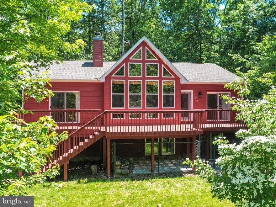 You will love this completely remodeled A-Frame Cabin located in a retreat-like setting in the well-established community of Shannondale.  This 3 bedroom, 3 full bath home is set on over a half-acre lot and features a long private driveway leading to the two car attached garage. This home offers gleaming hardwood floors, custom built-ins,  a wood burning stone fireplace, vaulted ceilings, and wall framed windows overlooking the front yard. There is so much beauty located throughout. The kitchen has been remodeled (August 2025) offering NEW QUARTZ COUNTERTOPS, NEW TILE BACKSPLASH, professionally painted cabinets, new hardware, and new kitchen sink.   There is a large owner's suite which includes a spacious walk-in closet. The master bathroom has been fully renovated (August 2025) featuring NEW CERAMIC TILE FLOORING,  NEW FREESTANDING CLAWFOOT BATHTUB with CERAMIC TILE BACKSPLASH, NEW GLASS ENCLOSED SHOWER,  new quartz counters on vanity, new exhaust fan, lighting, and faucets.  All three bedrooms on the main level have their own sliding glass doors leading to front or rear deck. The lower level has two living areas, a full bathroom, built-in shelving, and convenient access to laundry area.  NEW VINYL PLANK FLOORING was just installed in entire lower level.  Additional improvements include newer well pump, water softener, and water filtration system.  Stainless Steel Refrigerator is just one year of age. Roof was installed in 2018.  Enjoy the outdoor entertaining spaces including both front and rear decks.  There is a concrete pad underneath front deck that was previously used as a kennel and remains for next owner.  Amazing opportunity to own your own cabin in the woods whether it is your dream home, weekend retreat, or short term rental investment. NO HOA! Located just 2 miles from Shenandoah River public access and boat ramp.  Don’t miss your chance to own this gem!