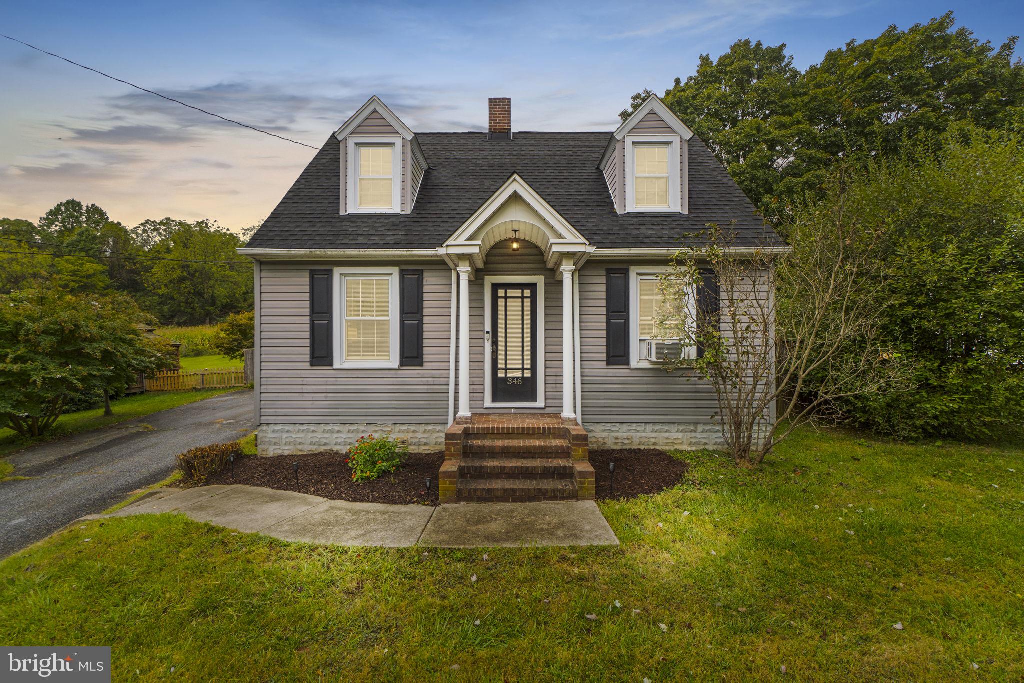 Welcome to 346 Ridge Road! This gorgeous home is quaint and just perfect, with true character and modern updates throughout! Pull into the large driveway, and you are met with an aesthetically pleasing home nestled on a gorgeous lot. Step in from the covered front porch and find a welcoming family room with a brick fireplace and mantel! Gleaming hardwood floors extend through the dining room! Crown Molding! Arched doorways! Updated windows which offer a ton of natural light throughout! Beautiful custom gourmet kitchen with white cabinets, tons of storage space, glass front cabinets, granite counters, ceramic tile floor, stainless steel appliances, and a custom backsplash. The sunroom is off the kitchen and is the perfect space to relax at the end of a long day or entertain your family and friends! This leads to the lovely rear yard that is large and flat! Upstairs, the hardwoods continue and you will find the primary suite, an additional bedroom, and a fully updated bath! The basement is finished and offers a rec room (with an exposed industrial ceiling), a custom bar, laundry, and tons of storage! The home also offers a one-car detached garage! This property will not last long. NO HOA! '24 Oil Tank! Schedule your showing today!