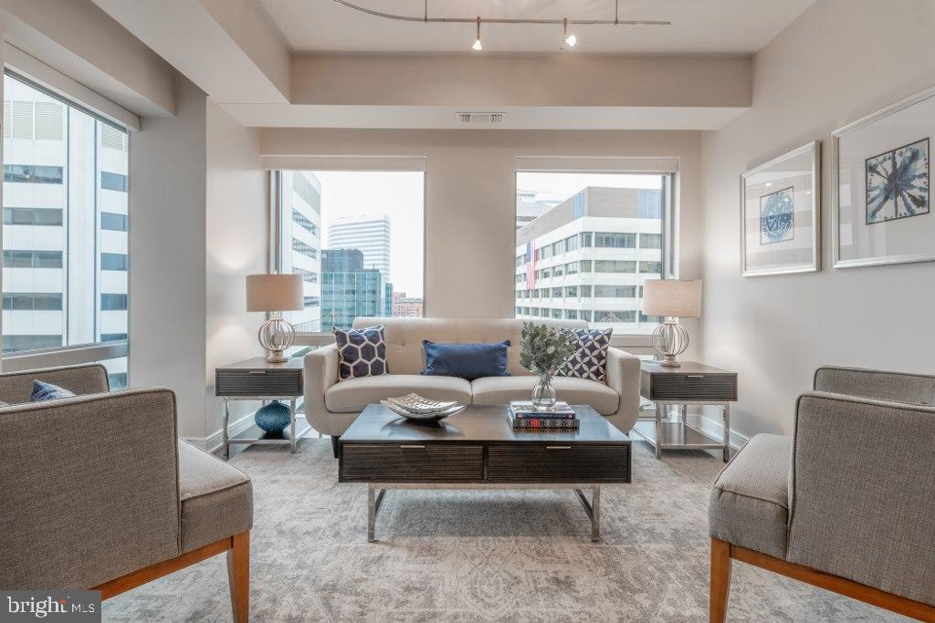 The seller said, 'Let’s price this condo that no one else would dare match - too good to pass up!!!"
- INCREDIBLE PRICE ADJUSTMENT for this amazing condo with monument views in a full service building!!
Discover contemporary luxury living at The Residences at Waterview, an architectural masterpiece overlooking the Potomac River in the heart of Rosslyn. Designed by the renowned architects Pei Cobb Freed & Partners, this stunning building has received numerous prestigious design awards!
The Meridian Hotel occupies the first twelve floors of the building, offering residents exclusive access to its world-class amenities, including convenient state-of-the-art fitness center. On the 31st floor, residents can retreat to the rooftop terrace, boasting unparalleled panoramic views of the city skyline and the river.
Unit #1403, a sunlit two-bedroom, two-bathroom residence, offers a captivating vista of Rosslyn, with glimpses of the river and the iconic Washington and Lincoln Monuments. This immaculate corner property exudes luxury, featuring Wood Mode kitchen and bathroom cabinets, high-end appliances such as Viking oven and cooktop, Subzero refrigerator, Dacor microwave, and Miele washer and dryer. Recently upgraded with warm hardwood floors and bedroom carpets, the residence also showcases elegantly marble-tiled bathrooms, and floor-to-ceiling windows.
The rooftop terrace has multiple seating areas and two grills with the beautiful views of Washington DC. The garage offers secure parking with EV chargers available and dedicated bike parking. A newly renovated gym provides a wonderful workout area. Residents have 24-hour concierge service, a tenant lounge, plus access to the Le Meridian hotel where they can enjoy discounts on rooms and dining. This unit comes with a deeded parking space and storage units are available. Utilities are included except for electricity. Pets < 80 lbs. allowed. Its prime location offers easy access to Georgetown, National Airport, and just one block from the Rosslyn Metro station. Experience the epitome of chic urban living at Waterview, where sophistication meets convenience in every detail. Its prime location offers easy access to Georgetown, National Airport, and just one block from the Rosslyn Metro station.