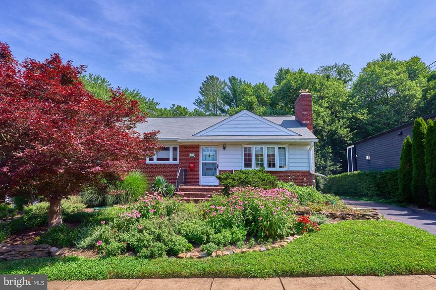 Welcome to this expanded brick rambler in the desirable Rock Spring neighborhood (historically known as Crescent Hills) of North Arlington. Originally built in 1955 with a thoughtful addition completed in the late 1980s, this 4-bedroom, 3-bath home sits on one of the largest lots in the neighborhood—and the largest on the block—at 21,038 sq. ft. (nearly a half acre!)

Lovingly cultivated by its longtime owners, the property has become a miniature farm-style retreat. Natural gardens and trademark wildflowers fill the grounds, attracting local wildlife including deer. A distinctive mural on the western wall depicts a rustic barn and cow, making this home truly one-of-a-kind and memorable.

Inside, the home offers a solid and functional layout across two finished levels. The main floor features a spacious living room with a masonry fireplace and gas insert, an open dining area, and an eat-in kitchen that opens directly to a wood deck—perfect for outdoor dining and entertaining. Three bedrooms, including the primary suite, complete the upper level. The walk-out lower level adds a flex suite/den (not considered a legal 5th bedroom due to window size), a recreation room, full bath, laundry, and flexible utility/storage spaces.

Recent improvement provides peace of mind: the roof was replaced in 2022 and is in good condition. While ready for cosmetic updates, the home’s sturdy structure and expansive footprint present an outstanding opportunity for renovation or future expansion. With a lot approaching half an acre, buyers can envision creating a dream residence with ample space for additions or outdoor amenities.

This location combines privacy with convenience. The property backs to private organization providing both a buffer and the possibility of pool membership just steps away. Those with school-age children will appreciate the short distance to Discovery Elementary, Williamsburg Middle, and Yorktown High School, as well as shopping and dining at the Harrison Street Shops. Commuters enjoy easy access to East Falls Church Metro (2 miles), I-66, and major commuter routes.

A rare offering of land (half acre!), character, and opportunity – this property is truly a standout in Rock Spring / Crescent Hills.