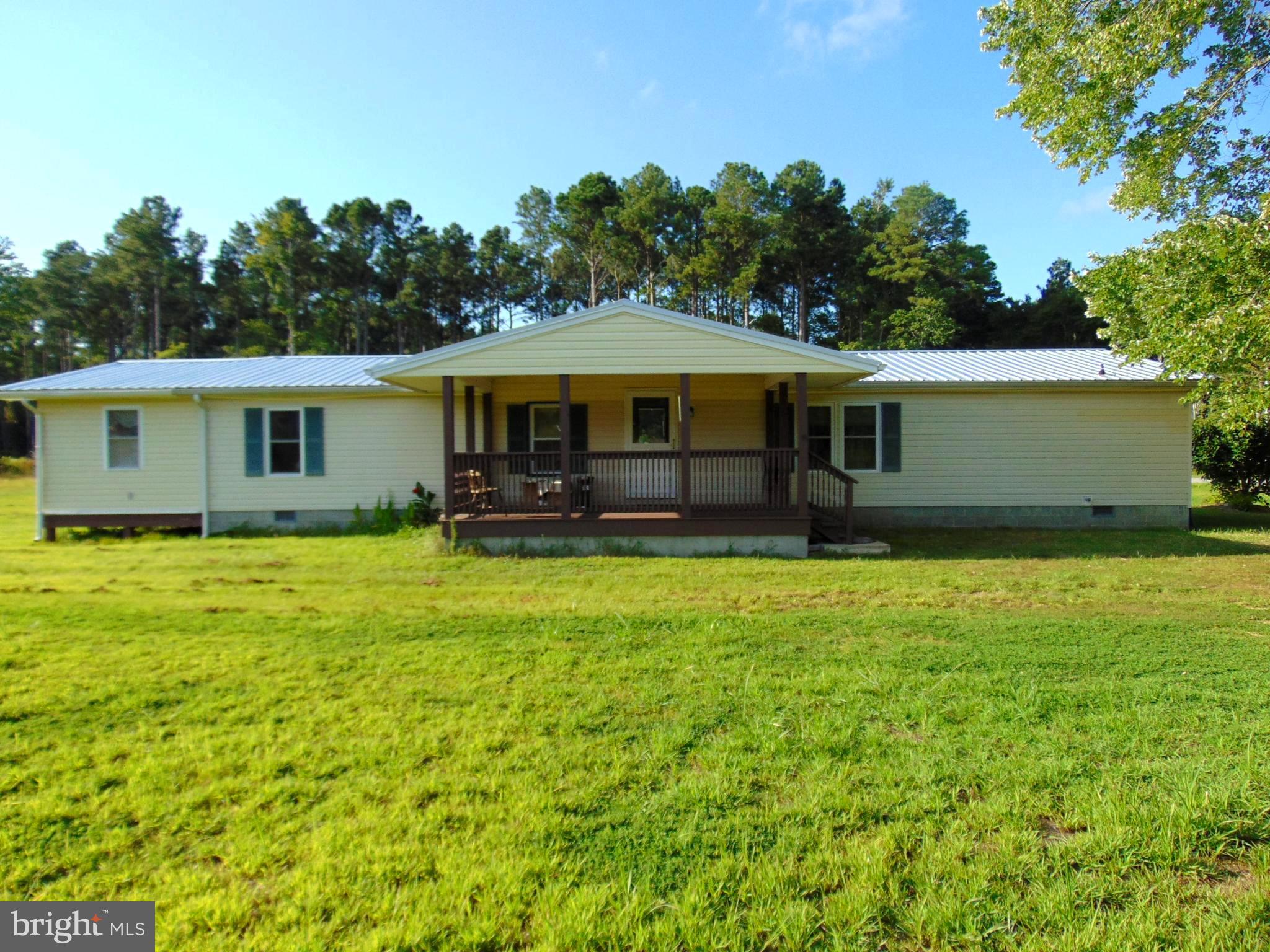 Have you been dreaming of living in the country with lots of space to move around? Then this could be your dream come true. This property includes a 3 bed 2 bath home situated on 9.58 acres. There is also a 30 ' X 40' three car garage with a concrete floor and new metal roof. One of the upgraded features of the home are a large covered porch that overlooks 3 sides of the property. You can entertain guests or watch the wildlife as you drink your morning coffee. A new metal roof along with vinyl siding make for easy maintenance on the outside. The original 1612 square foot home was an added on to include back and side additions which increase the square footage by approximately 390 square feet making the total square footage of the home to over 2000 sq. feet. The front porch enters into a foyer and oversized living room with cathedral ceiling and a working wood fireplace. Directly behind this is the spacious kitchen with center island. Adjoining the kitchen is a family room which is presently used as a dining room. There is also a separate formal dining area in the front of the house. The main bedroom includes its own en suite and walk in closet. The split floor plan places the other two bedrooms on the other side of the house. A full bath is shared by these two bedrooms. The utility room is located in this area. From the utility room, an addition was added which provides more living space. Some possibilities for this space are a man cave, a woman's retreat, a playroom or another family room. This area has 2 doors to the outside and has only heat at the present time. In the back yard, the huge detached 3 car garage can easily accommodate 3 vehicles and still give plenty of space for a shop, storage or a place for your toys. 8.58 acres are part of the forestry program. It was clear cut and leveled and is now just waiting for trees to be replanted. The seller has already paid for this so there would be no expense for the buyer. In the future, trees can be harvested and sold. This will provide privacy and shade in the future. The remaining property gives you ample space for a yard and outdoor activities. Located a couple of miles off of Route 13 there is easy access to town for shopping, dining and entertainment. Wallops, Chincoteague and the beaches are only 40 minutes away. Living in the country with almost 10 acres can make your dream a reality. Set up your appointment today. Seller is open to closing assistance!!