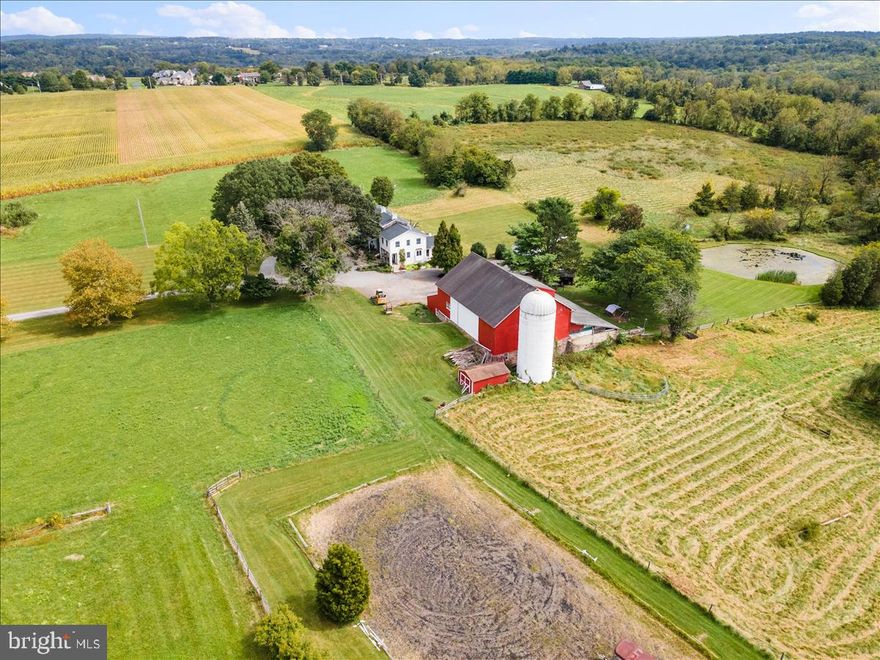 NEW PRICE!  This classic Bucks County fieldstone farmhouse on over 20 acres with a spring-fed pond is surrounded by the preserved farms and vineyards of Warwick Township.  With beautiful views of the countryside from every window, life at Night Sight Farm is like living in a painting.  In the highly regarded Central Bucks School District, the circa 1860 country estate is perfect for the horse enthusiast with its multiple pastures and large bank barn with 8 stalls, tack room, feed room and hay loft. A Conservation Easement identifies two subdividable, 2+ acre homesites located on opposite corners of the property, offering a unique opportunity for a future family compound or the option to sell one or both lots.  The freshly painted interior features exposed stone walls, original random width flooring  and deep-set window sills.  A recently remodeled eat-in kitchen in the newer section of the house has high-end stainless steel appliances, and looks out to the sun-filled family room with vaulted ceiling and palladium windows. Through french doors off the family room is the library with window seat, radiant heat and a wall of bookshelves.  Beyond that is the large garden room with access to the rear bluestone patio.  A beautiful dining room with a walk-in fireplace leads to the very spacious living room, with fireplace.  On the second floor is the primary bedroom and bath, walk-in closet, as well as a sitting room plus two other bedrooms and a full bath.  The laundry is also located on this floor. The third floor offers two additional bedrooms, a sitting room and a full bath. Easy travel to New York City (90 minutes to Holland Tunnel), Philadelphia (50 minutes), and New Jersey beaches.