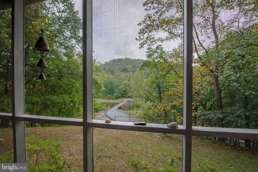 Welcome to the "bridge keeper's bungalow"!  This lovely little lair is nestled off Compton Ln and Rockford Rd just before the low water bridge with views of the river and the bridge!  Riverfront property includes 3 lots totaling approximately 1.45 acres with one lot extending across Rockford Rd with very little restriction.  This has all kinds of possibilities!  One bedroom and one bath with galley style kitchen, living room with fireplace, screened porch for afternoon naps overlooking the river, covered deck for outdoor dining offers river view as well.  House, 2 sheds and plenty of useable yard space appear to be out of the floodplain.  Stone path to the river is overgrown but can be updated and maintained for easier direct river access. Crawl space is accessible and dry.. Oil tank is no longer in use-heating was converted to electric forced air furnace. Currently owner's have Direct TV and landline phone through Frontier-no internet hooked up at this time. Waterfront footage is estimated. PROFESSIONAL AERIAL PHOTOS TO FOLLOW