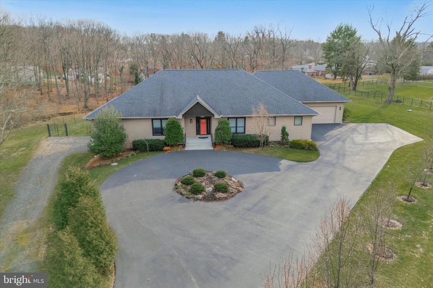 Welcome to 711 Stoler Avenue, a true masterpiece of architectural excellence. This distinguished FIRST FLOOR LIVING HOME represents the pinnacle of refined living. Boasting 3 bedrooms and 5.5 bathrooms on the main floor and 2 more bedrooms and a full bath in the attached apartment on the lower level rounding out at over 5600 square feet of meticulously designed living space. Nestled on nearly 3 acres of pristine land on one of the area's most charming streets, this private retreat is surrounded by lush woods and a tranquil stream, creating a serene oasis.  As you enter through the grand circular driveway and step into the extravagant foyer, you'll be greeted by 9-foot ceilings and designer-laid maple hardwood flooring that sets the tone for the exquisite craftsmanship found throughout the home. The main floor boasts a 37-foot great room adorned with artistic hardwood flooring, a luxurious flush wall propane-fueled fireplace, and a swanky wet bar with a fridge and ample storage for glasses. Floor-to-ceiling windows flood the space with natural light and offer breathtaking views of the surrounding landscape. The custom-crafted kitchen is a chef's dream, equipped with high-end appliances including a Sub-Zero built-in refrigerator and Miele dishwasher, a Miele induction cooktop as well as convenient drawer storage with heavy-rated hardware for all your culinary needs. The adjacent  dining area and large walk-in pantry make hosting gatherings a breeze.
Discover the magnificent primary suite, which boasts unparalleled privacy and is adorned with custom-fitted dual walk-in closets featuring intimate dressing rooms, a separate shoe closet, and dual private ensuite baths. The ensuite baths include identical shower stalls with seats, individual vanities, and built-in shelving.
Continuing down the hall, you will find a library complete with custom built-in bookcases and shelving, wooden flooring, split air conditioning, a ceiling fan, and a closet.  Further along the secondary hallway, you will encounter two sizable bedrooms, each featuring hardwood flooring and ample closet space. Each bedroom is accompanied by its own individual full-tiled bathroom, and all bedrooms are equipped with Casablanca fans operated by remote controls. Rounding out the main floor is a half bath, a den/office providing a glass pane door leading to the substantial indoor heated swimming pool with a full bath and a fully outfitted laundry room, and a mudroom area with access to the oversized garage offering plenty of built-in shelving. The home includes a full basement, with one half designed as a two-bedroom plus flex-room apartment suitable for accommodating a college student, in-laws, or an au pair. This apartment is equipped with a full kitchen, bathroom, stacked washer-dryer, and a private entrance that remains accessible to the main house. The other half of the basement is intended for family activities or as a playroom.  Situated within the acclaimed North Penn School District, this residence enjoys proximity to several prestigious private schools in the vicinity, close to plenty of shopping and dining and easy access to major highways and public transportation.  Indulge in the epitome of opulent living within this custom-designed ranch style home, where no detail has been spared in crafting an unmatched experience of luxury, comfort, and sophistication.