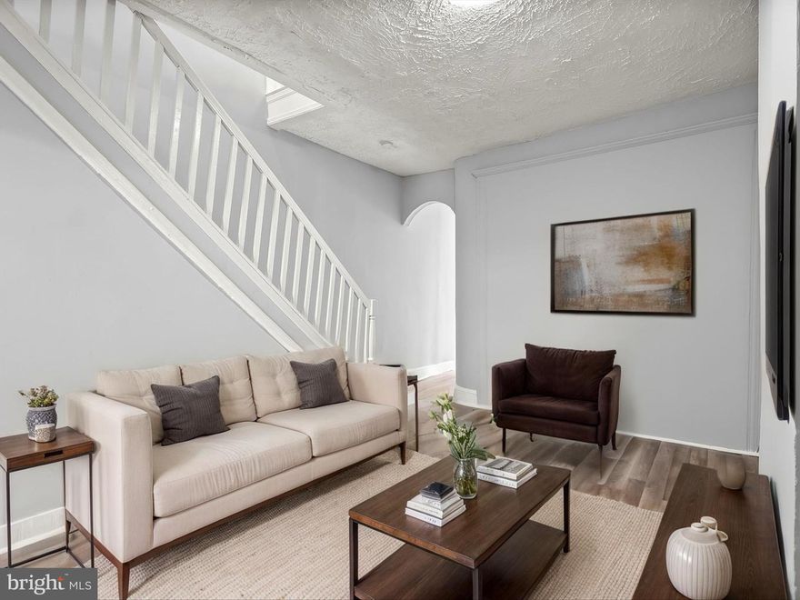 This 4-bedroom, 1.5-bath home offers historic details and practical updates, including a fresh neutral color palette throughout, new stair carpet, and a newly installed cement rear patio.  The entry vestibule retains its original tile, leading to the main level with newer wood-look vinyl flooring for easy upkeep. A bright bedroom sits at the front of the home, followed by a living room that opens to the kitchen with a gas range and granite countertops. From here, step out to the fenced rear patio, a potential parking pad. A half bath completes the main level.
Upstairs, a skylight brings light to the hallway connecting three bedrooms and a full bath with a tub/shower combination. The unfinished basement provides plenty of storage space and laundry area.  
The location offers convenient access to Patterson Park, the Highlandtown arts and shopping district, Oriole Park at Camden Yards, and Lexington Market. Nearby public transit options include the Johns Hopkins Metro station and the Charm City Circulator.
Enjoy city living with green space, local culture, and everyday conveniences right at your doorstep in Patterson Park.
Note:  Select interior photos have been virtually staged.