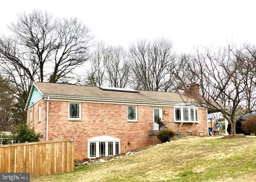 This home has been completely remodeled and is ready for new occupants. The home sits on over 1/2 an acre located near Tyson's Corner and major commuting routes with a fenced back yard. Multilevel deck with hot tub. The kitchen has stainless steel appliances, a gas range and quartz counter tops. Three bedrooms on main level and one in the basement. The home features multiple locations for home schooling or working from home. There is an outside bonus building with French doors and a deck that has wood floors, air conditioning and heat, electric and internet. Owner is will to leave furniture in bonus building (as-is) if desired. There are even 2 sets of washer and dryers, one on each level! Walk out basement with full bath. There is a large carport with storage and the driveway could accommodate 8 cars if necessary. There is also a connector trail to the Metro that makes it approximately a mile away. HOT TUB and WINE FRIDGE "AS-IS"!