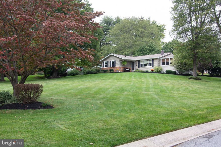 ALL OFFERS DUE 10/9 AT 5 PM.  OWN THE HOME OF AN INTERIOR DECORATOR!! This 4 bedroom, 3 full bath rancher is something right out of a magazine. With the owner being an interior decorator, no detail was forgotten! Walk in to be greeted by gleaming hardwood floors and the large open space that everyone loves. The eat-in kitchen with a huge island as the centerpiece features granite counters and custom-made cabinets. The stainless steel appliances shine, the tile backsplash is beautiful, and the hanging lights are the perfect accent to this area. The kitchen also features inset lighting and a pot filler right over the stove for the gourmet cook! The eat-in area fits a large kitchen table and the sliding glass doors allow for so much natural light! The living room boasts a wood-burning fireplace surrounded by built-in shelving. The large picture window lets in even more sunlight and the built-in ceiling speakers allow for a great ambiance as the music flows throughout the house. Head down the hall to find the spacious primary bedroom which features its own updated en-suite bath with heated floors and a walk-in shower. A walk-in closet (with laundry chute), and then a second closet for even more storage! The bedroom is carpeted, but there are hardwood floors under the carpet! Continue down the hall for two more bedrooms and a fully updated hall bath with custom cabinets, a built-in linen closet, and heated floors.  Down the basement steps, you will find a fully finished family room that has plenty of closet space. A great place to gather and watch the big game or put your home office. The bathroom features granite counters and a gorgeous walk-in shower. The fourth bedroom (a true 4th bedroom!) has a walk-in closet and egress window.  There is a laundry room along with plenty of storage to make this the perfect family basement! But wait...there is more!! Another feature of this beautiful home is the three-season porch! Sit and relax as the wind gently flows through this room and you overlook your large front yard. What a great room for early morning coffee, late afternoon beverages, or dinner with the whole family. And yet it continues...the paver patio off the kitchen slider is stunning! Featuring a built-in paver fire-pit, and surrounded by beautiful plants for privacy, it is another oasis to enjoy! All this home, sitting on a premium corner lot with 2 cul-de-sac streets, and a list of upgrades a mile-long! Every item in the home is serviced regularly, or has been replaced by these owners who have lived here and enjoyed this home for 30 years! The driveway has even been expanded and repaved for extra parking!  The HOA is voluntary and is only $15 a year...it is just there to maintain a beautiful 9-acre piece of land that the whole neighborhood can enjoy. This land has a stream running through it and is a perfect place for kids to play or to take a nice relaxing walk. This home is nestled inside a neighborhood, but is only minutes from commuter routes!  You may have just found the perfect home! (The seller's are open to selling much of the furniture.)