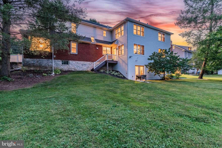 Welcome to this stunning  home, gracefully updated and set against the picturesque backdrop of Letort Spring Run. This beautifully maintained 5-bedroom, 3-bath residence boasts gleaming Brazilian Cherry hardwood floors that flow seamlessly throughout most of the main level. The living room features hardwood floors and elegant gas fireplace framed by marble with wood mantel, while the adjacent family room features an electric fireplace and opens to a charming side veranda overlooking serene water views. The gourmet kitchen is a chef’s delight, showcasing granite countertops, a peninsula island, custom white cabinetry, a 5-burner gas stove with a pot filler, a wall oven with a warming drawer, and stainless steel appliances. A dedicated den with built-ins provides an ideal home office space, and a full bath with slate floors adds convenience. Upstairs, the expansive primary bedroom offers tranquil views and a luxurious en-suite bath with porcelain floors, a walk-in tile shower, and a soaking tub. Four additional bedrooms share a full bath, while one bedroom doubles as a sitting room with a wet bar and spectacular water views. The lower level is an exposed walkout with a rough-in for an additional bathroom. Mechanicals include dual zone A/C, two 200-amp electric panels, a gas furnace, and a gas water heater and an electric water heater. This home has been thoughtfully expanded and updated, blending classic charm with modern amenities in a truly picturesque setting. The original part of the home was built in the 1920's , in 2013 this home was more than doubled in size with the custom addition done by C&C Construction.