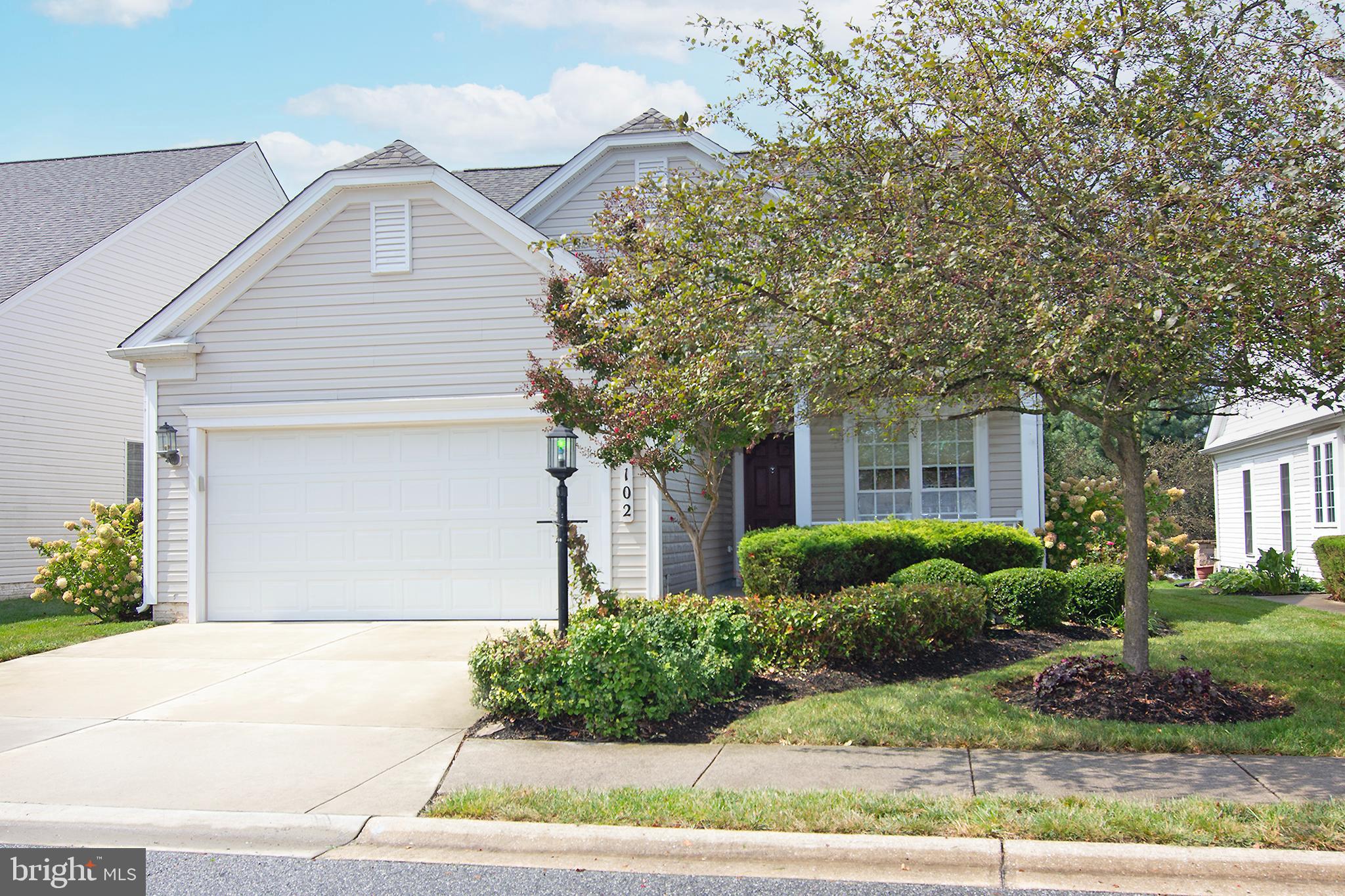 This was the model home for Carroll Vista with many upgrades. This is the JAMES MODEL with an EXTENDED living room with a fireplace. Beautiful wood floors in the living room and dining room. Decorative trim. The kitchen has a breakfast area, maple cabinets, granite counters, newer refrigerator. The professionally decorated window valances and blinds are included. The primary bedroom has a tray ceiling, enormous walk in closet and full bath (shower with glass doors). All the artwork thru out the house is included. The washer & Dryer are included. Spacious 2 car garage. Deck overlooks a lush greenspace... a short walk to the clubhouse.