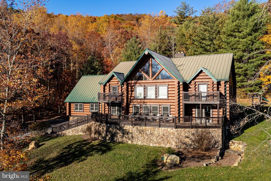 Experience unparalleled luxury and breathtaking mountain views at this one-of-a-kind lodge. Relax on the large deck and watch deer and wildlife frolic through the yard. This exceptional property boasts 7 bedrooms (with potential for more), two luxurious primary suites, and is constructed with stunning 16-inch solid wood logs. Enjoy 5 mini-splits for controlled comfort, central heat and air, a whole-house generator and 3 gas fireplaces. There are 26 ft vaulted ceilings, exquisite stonework thought-out, and so much detail. There is some fenced acreage that offers endless possibilities. The home is visible from Hazel Top pull off in Shenandoah National Park. This luxury lodge is more than a home; it's a legacy. There is additional acreage that can be purchased, some border the National Park.