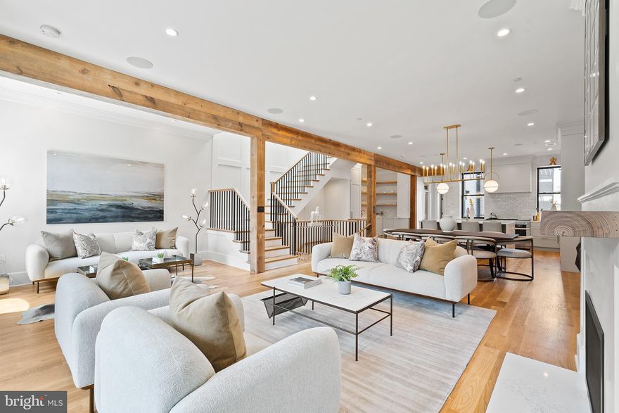 MuSoLit Residences is an exciting new development that meticulously encapsulates luxury refinement and contemporary living within a rich piece of Logan Circle history.  Born out of the neighborhood’s residential construction boom in the 1880s, the house was commissioned by George Prince,  a prominent photographer of U.S. Presidents. The design was conceived by Thomas Franklin Schneider, one of DC most prolific Architects, famous for works like the Smithsonian’s Arts and Industries Building, The Cairo on 16th & Q and  Eastern Market on Capitol Hill.

With 130 years of history, the property was renovated by a neighboring developer along with Four Brothers Design & Build. The developers worked with Architect and designer, Sarah Snouffer, to “transition 6,170 Sq. Ft. of historic property into two, upscale, welcoming and open units” that took full advantage of the 25’ foot width; extraordinary for a Washington DC townhome. Through the team’s skill and talent, they carefully crafted 4 levels of soaring space into two, awe-inspiring units; each measuring over 3,000 Sq. Ft. and boasting 4 bedrooms, 4 full bathrooms with specially bestowed add-ons. Configured around a spectacular set of custom-built white oak and black metal stairs, each individual residence’s main level features a stacked living, dining, and kitchen open layout with powder rooms, pantries, and closets and a primary suite, with one uniquely offering an additional suite with Kitchenette. Thoughtful tributes to MuSoLit Residences’ rich past can be found through the designer’s preservation of the large entertaining spaces, high ceilings, the use of salvaged joists to accent custom built-ins and the restoration of the front façade’s historic integrity.  A purposeful mix of high textural counter and tile materials, black, brushed-brass and architectural bronze metals, and a neutral color palette, intertwine into a rich tapestry of serenity and sleekness at every turn.

In the 1920s, the building became the MuSoLit Club, which for many decades was one of the city’s most exclusive African American, invitation-only clubs and an epicenter of social, intellectual, political and cultural life. In the 1960s, Howard University’s Alpha Sigma Chapter of the Phi Beta Sigma Fraternity took ownership of the residence and carried forth the MuSoLit spirit with its own acts of Brotherhood, Scholarship, and Service.

Residence Two at MuSoLit exceeds all expectations of urban living in style, floor plan and design.  Not only does it have all the bespoke finishes that come standard at MuSoLit, but the floor plan is more generous allowing all 25’ to be used throughout the home.  This unique floor plan allows for an extra area off the formal living room and an additional south-facing window to allow more light in.   The upper unit at MuSoLit boasts an enormous kitchen, butler's pantry, and an additional wet bar including  an ice maker, wine fridge, and more storage.  This home has 2 half-baths which is ideal for entertaining in the primary living area of the home or on the private roof deck.  Two of the bedroom suites have doors leading out to additional outdoor space.  The primary bedroom suite boasts ceilings almost 19’ high and salvaged joists to provide balance and architectural detail.  Reclaimed wood is also used as bookshelves on either side of the bed to create warmth.  A walk-in closet completes the perfect bedroom suite.