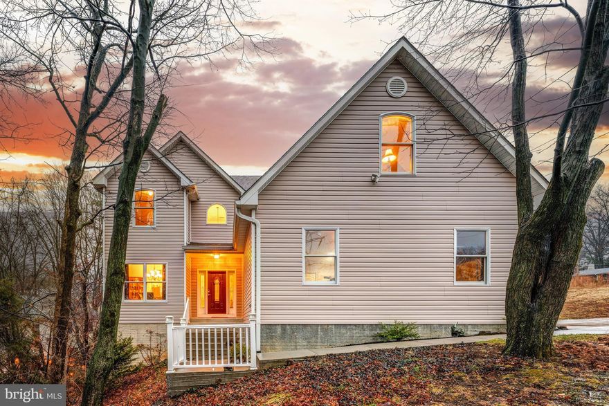 It’s not often you find this kind of space and privacy this close to the heart of Alexandria. Set on 1.6 acres and built in 2012, this 4,100 square foot custom home offers the rare combination of land, modern construction, and true convenience just 1.5 miles from the Huntington Metro. Inside, the layout is designed for the way people actually live today, with an open flow between the kitchen, dining, and family spaces while still giving each room its own identity. The formal dining room connects easily to the kitchen, where maple 42 inch cabinetry, granite counters, stainless steel appliances, a gas range, and a comfortable breakfast area make it a natural gathering spot for everyday life or hosting friends. Just beyond, the family room centers around a gas fireplace with built-ins and opens to a private deck overlooking the peaceful backyard. The main level also offers something buyers are always searching for but rarely find: a full bedroom and beautifully finished bath with large format tile and a maple vanity topped with granite, perfect for guests, multi-generational living, or a quiet home office. Hardwood floors, recessed lighting, and a main level laundry room round out a floor that feels thoughtful and easy to live in. Upstairs, the primary suite is filled with natural light and includes a walk-in closet and a spacious bath with dual vanities, a soaking tub, and a large separate shower. Three additional bedrooms share a generous hall bath finished with large format tile and a granite topped vanity. Every bedroom enjoys large windows, ceiling fans, and a bright, airy feel. The walkout lower level adds another dimension to the home with full-size windows, recessed lighting, LVP flooring, and a huge rec room ready for a pool table, movie nights, or game day gatherings, along with a mini kitchen and eat-in area that makes entertaining easy. There is also a full bedroom and bath, ideal for extended guests or long term stays, and direct access to the backyard through the walkout doors. Outside, the setting feels tucked away and private with room to breathe, while the oversized two-car garage, EV charger, two-zone HVAC system, on-demand gas water heater, and long driveway with plenty of parking make everyday life simple and practical. Let's not forget about the solar panels that ensure your electricity bill is immune from Dominion Energy's continued price hikes. And while the home feels peaceful and removed, the location keeps you connected to everything that makes this part of Northern Virginia so desirable. The Huntington Metro is just 1.5 miles away, with easy access to the VRE, Amtrak, I-495, I-95, Route 1, Reagan National Airport, Fort Belvoir, and downtown DC. Old Town Alexandria, Del Ray, and National Harbor are all minutes away, and Hoffman Town Center with Wegmans, restaurants, shopping, and entertainment is close enough to enjoy regularly. Homes offering this much land, this much house, and this level of access to the Metro and the city simply do not come along very often.