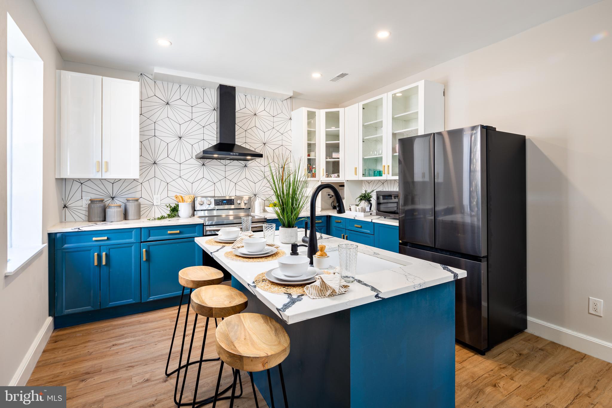 Welcome home to this STUNNING end of group historical and unique rowhome in the coveted Otterbein neighborhood! Located safely across from the Federal Reserve Bank, 2 quick left turns away from I95 and just STEPS (literally) from both Camden Yards and M&T Bank Stadium (Go O’s and Ravens), you could not ask for a better location. Oh anddd it’s easy to walk into Federal Hill, or any downtown locations!
Walk in and be blown away by the fully renovated, modern, gourmet kitchen with top of the line appliances, high end quartz countertops and an island with seating for 3 that opens into your spacious living area with beautiful engineered wood floors. Look up to see all the way to the ceiling of the home! An open area creates an airy, creative and inviting atmosphere next to the beautiful and classic spiral staircase extending from the fully finished basement up to the third floor.
Primary suites, each with their own updated bathroom on the second and third floors each also have their own sitting room. Use as an office, reading nook or creative space. And don’t miss the rooftop deck accessed through the third floor primary bedroom! You can hear all of the Orioles games and see the Friday night home game fireworks. Concerned about furniture…don’t worry, there’s a pulley hook in the ceiling for ease of moving furniture in and out.
This unique and beautifully updated home in one of Baltimore’s oldest neighborhoods won’t last long. Come see it today!!