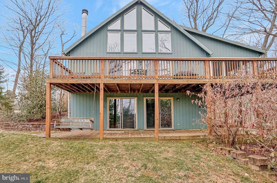 Beautiful modified Elmwood style home in The Woods Resort.  Class A membership available.  Stunning 3 story home with screen porch and large deck plus walk out basement. Home is situated on a nice wooded lot with paved drive. There are hardwood floors throughout the main level with vaulted ceiling and loads of natural light from the wall of windows. Brick fireplace, beams and artistic fixtures complete this charming space.  There are two large bedrooms and a full bath on the main level. The 2nd floor loft holds the primary bedroom complete with vaulted ceilings, large windows, full bath and walk-in closet. Downstairs the lowest level is the recreation room complete with sitting are and game area. The den adds privacy in this space.  The 3rd full bath is on this level with a walk-in shower.  Laundry room and three separate storage areas complete this space. Home comes furnished*.