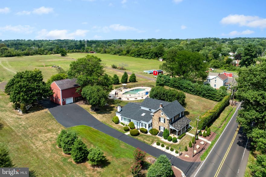 Country charm doesn’t have to be complicated.  Come visit this Bucks County farmhouse circa 1825, on over 7 usable acres, offering flexibility for horses, or small-scale farming. or simply more space to enjoy. This gorgeous stone home has been expanded to create a comfortable, functional layout, featuring a generous living room with a stone fireplace, a main-floor primary suite, and convenient first-floor laundry. The original character is still very much present, complemented by updates that make daily living more practical. Outdoors, the setting speaks for itself. There’s room to spread out, entertain, or slow things down—spend summer days by the in-ground pool, or make use of the open acreage however it suits you. The bank barn offers stalls and storage, and the detached garage/shed provides additional space for equipment, hobbies, or a workshop.
Located just minutes from Doylestown with easy access to Route 309, and within the popular Pennridge School District, this is a setting that balances privacy with convenience.
Call today for your private tour