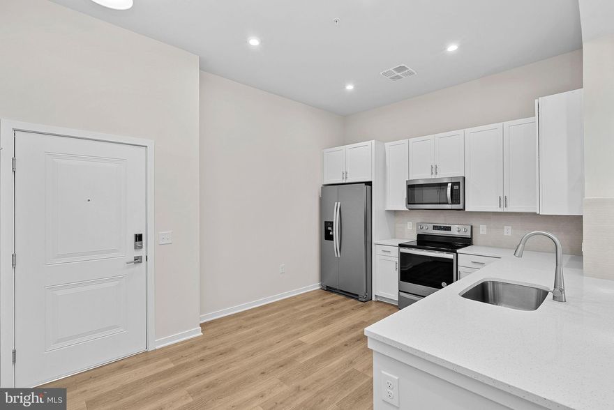 **FINAL HOMES** NEW CONSTRUCTION / 55+ COMMUNITY Special all-in price! Aspen home for immediate move-in. This 4th-floor home (top floor) has two bedrooms & two bath with southeast views. Hosting friends is ideal in your open-concept living & dining room. Adjacent to the kitchen with the large pantry, you'll find a flex space that you can transform into your own expansive living and dining room or a place for your favorite hobbies. Relax and unwind in your spacious primary bathroom, equipped with an oversized shower & dual closets for your comfort. Plus, enjoy a covered deck perfect for unwinding or gathering with loved ones. Blinds are included on all windows. Revel in a resort-like getaway every day in the Aspen. Dedicated covered parking space and storage unit included. **BY APPOINTMENT ONLY** **BY APPOINTMENT ONLY*** *For a limited time receive $10,000 in Closing Costs through 10/31/25 (Closing assistance tied to Choice Lender; must settle on or before 12/31/2025).*  Additional Restrictions may apply. Gatherings® at Potomac Station offers 55+ living near Leesburg’s vibrant dining, live music, and art scene. Enjoy green spaces like Ida Lee Park, top healthcare at Inova Loudoun, and easy access to shops, trails, and cultural events. This vibrant community includes a private fitness center & yoga studio and a center courtyard with walking path. Perfect for an active lifestyle! With low-maintenance design and fewer common repairs, you’ll spend less time on upkeep and more time enjoying the comfort of home. Enjoy a life free of yardwork or shoveling. Landscaping and upkeep are handled for you, so you can spend your time how you want to. Look for parking along California Avenue near the paved steps/ramp between the main buildings. Follow the signs and take the steps or ramp to our building entrance. Please use keypad to call our 2nd-floor SALES OFFICE.