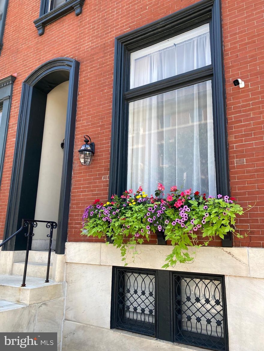 Nestled within the enchanting historic district of Mt. Vernon, this captivating property seamlessly combines timeless charm with contemporary potential. This home boasts original wood white oak with mahogany accent flooring, meticulous attention to historic detail, and exquisite finishes that pay homage to its heritage.  With nearly 4,000 square feet of living space, this residence offers a grandeur rarely found.

Upon stepping through the formal entry, the residence's splendor unfolds, with 10-foot ceilings on the first level creating an expansive and graceful ambiance. The formal parlor, adorned with a decorative fireplace, sets the tone for elegant living. Adjacent to it, the dining room and a dedicated bar area make this space perfect for entertaining. A tastefully remodeled half bath on the first floor adds both convenience and style to daily life.

Ascending the gracefully curved staircase to the second level, you'll find 9-foot ceilings and thoughtful modern updates. The gourmet-style kitchen features top-of-the-line appliances, granite countertops, and a butler's pantry, catering to culinary enthusiasts. An additional remodeled half bath, an expansive family room, and a home office offer versatility and comfort for various lifestyle needs.

Venturing to the third level reveals a primary suite that epitomizes opulence and a newly renovated bathroom complete with a soothing soaking tub for ultimate relaxation. Bedroom #2 boasts an en-suite bathroom for added privacy, while a conveniently located laundry room simplifies daily routines.

The fourth level presents two more bedrooms, a generously sized walk-in closet, and a shared hall bath with both tub and standup shower, offering diverse living options for family or guests.

The lower-level basement opens to a private brick courtyard entrance and storage shed, holding tremendous potential. With the right vision, this space could be transformed into a studio apartment, creating an income-generating opportunity or a separate living space for a family member. Adding to its allure, the property includes adjacent off-street parking, a rare gem in this neighborhood.

Positioned perfectly, this property is less than a half a mile from Penn Station, making it an ideal choice for commuters. Additionally, it's in close proximity to cultural and educational institutions such as MICA, the University of Baltimore, Meyerhoff Symphony Hall, and the Lyric Opera House. Mt. Vernon's numerous restaurants and amenities are just a short walk away, enhancing the convenience and vibrancy of this location.

What sets this property apart is its unique C-2 zoning that allows for a wide range of potential uses, including general residential, commercial, office, and retail. This flexibility makes it ideal for a live/work setup, fostering creativity and innovation in shaping the future of this remarkable space.

Don't miss the opportunity to own a piece of Mt. Vernon's history while creating a modern masterpiece. Schedule a viewing and explore the endless possibilities this property has to offer. It's a chance to own a piece of history and reimagine it for the modern era.