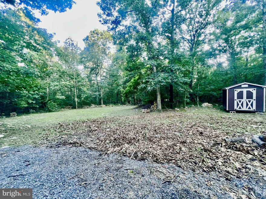 *Private Rural Retreat Opportunity!*
Just under an Acre Lot for Sale

Escape to the countryside with this serene, private retreat! This beautiful lot, nestled in the Massanutten Mountain, features a wooded area and a quaint clearing with easy access, perfect for building your dream home or getaway.

*Lot Features:*. 

- Electricity, well, and septic already installed
- Circle driveway with additional 40 tons of gravel for a smooth surface
- Brand-new 8x10 shed for storage or hobbies

*Subdivision Amenities:*
Owners-only bathhouse with hot water for added convenience and luxury
Subdivision parking lot for George Washington National Forest access for hunting and outdoor enthusiasts
*Location:*
Just 5 minutes from Shenandoah River access for kayaking, fishing, or relaxation
Only 10 minutes from Luray Caverns, a world-famous attraction
15 minutes to Skyline Drive entrance 
 20 minutes from Bryce and Massanutten ski resorts and water parks 
20 minutes from I-81
2 hours SW of Washington, DC


*Perfect for:*
- Nature lovers and outdoor enthusiasts
- Hunters looking for a base camp or hunting lodge
- Those seeking a peaceful retreat or vacation home
- Builders looking for a serene spot to create their dream home

Don't miss this opportunity to own a piece of rural paradise! Contact us today to schedule a viewing and make this property yours!
