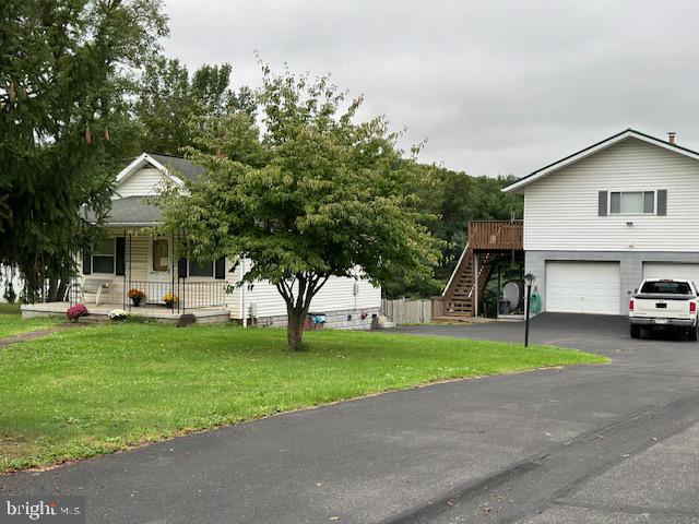 You have to see this to appreciate it. So many options. Rent the small Bungalow while living in the two bedroom apartment above a spacious, heated 4 car garage. Two nice open lots behind that can be subdivided or sold as one with their own separate entrance and already plumbed for water and sewage.